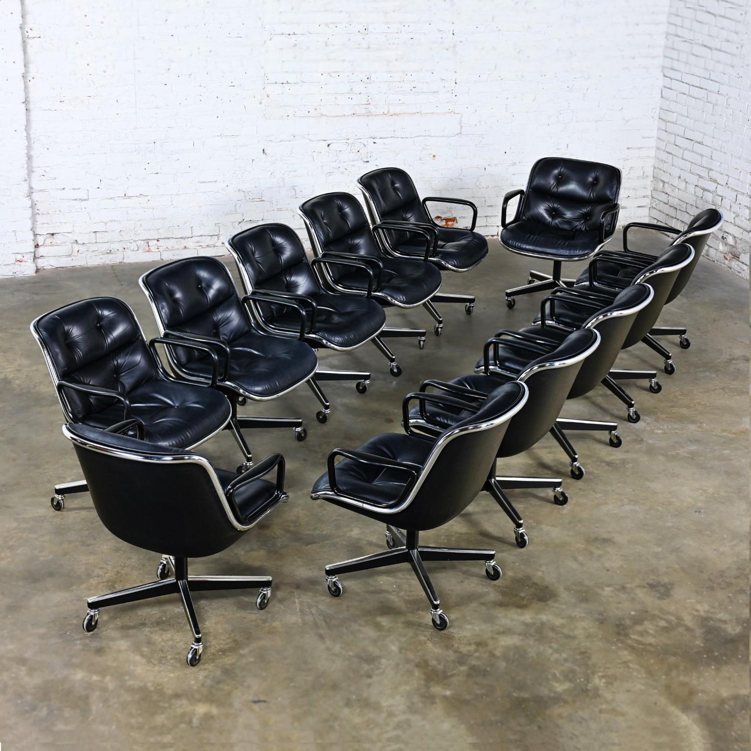 Timeless MCM (Mid-Century Modern) to Modern Executive armchairs by Charles Pollock for Knoll set of 12. Each chair is comprised of a black leather seat and back with button detail, aluminum band, chrome shaft, black plastic arms, and a 4-prong