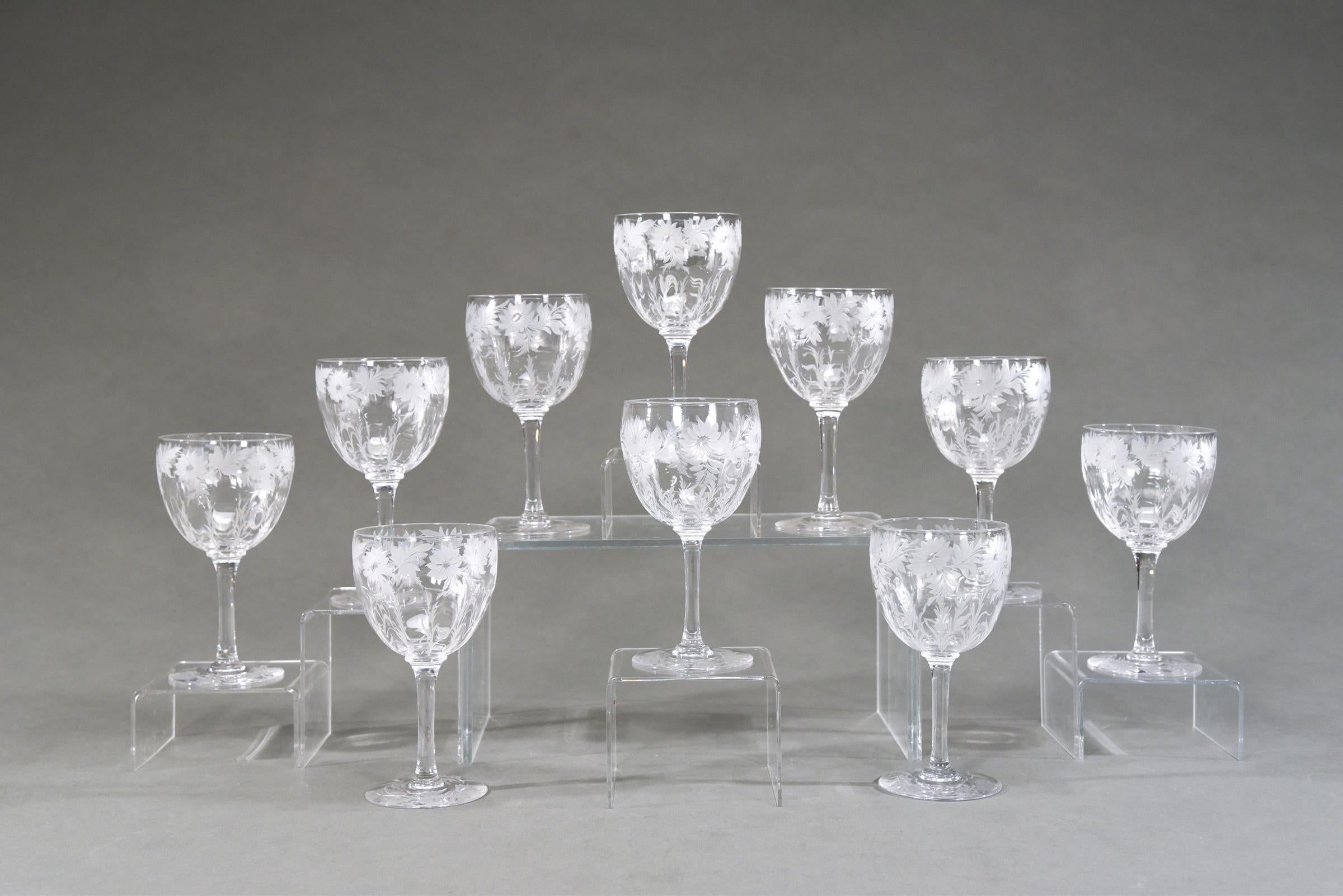 This set of 12 signed Libbey handblown goblets depict an iconic Arts and Crafts pattern of wheel cut flowers alternating with leaves along the rim. The engraving remains frosted which gives them a wonderful contrast to the clear crystal bowl. The