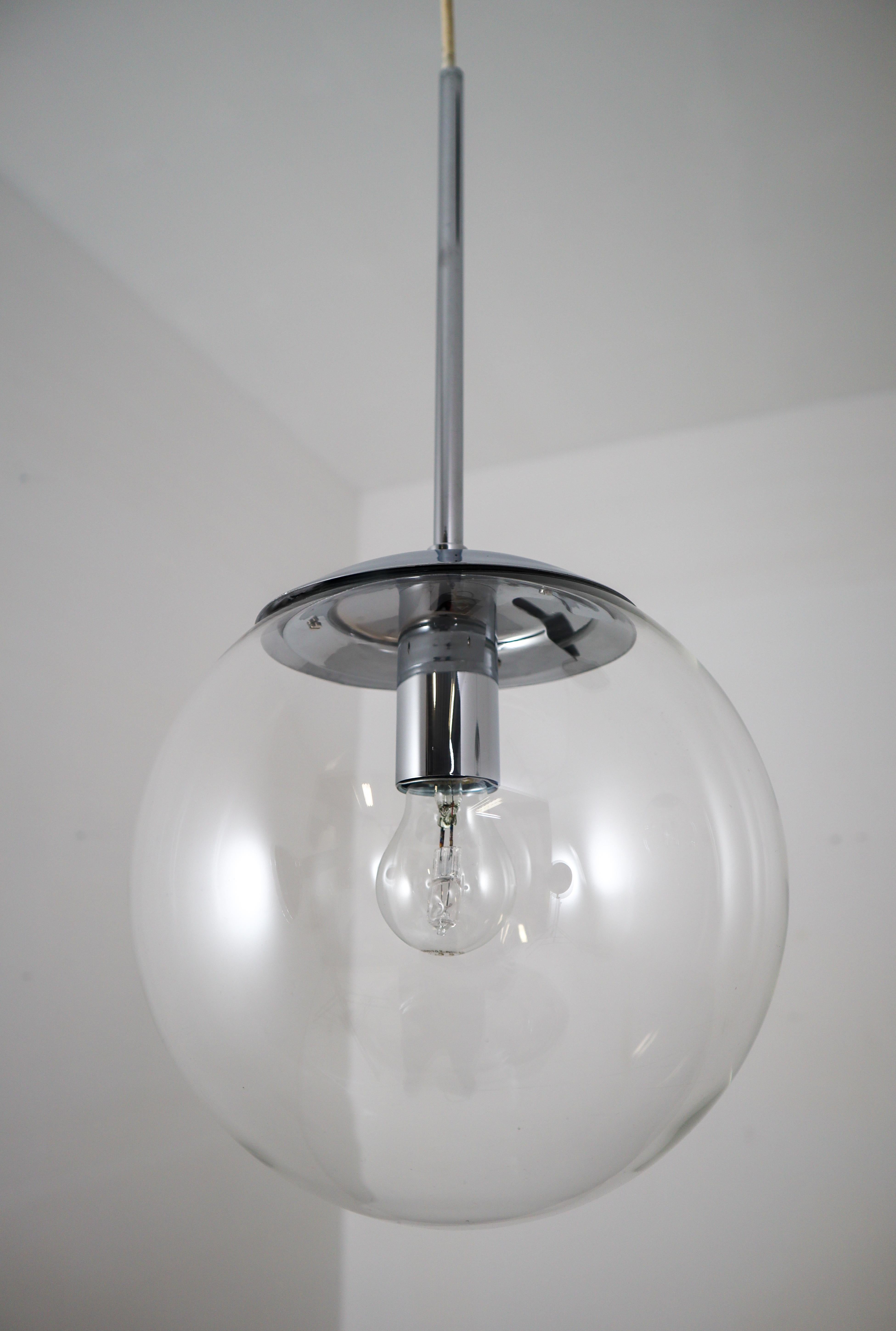 Hand blown pendant lamps were made by the German manufacturer Limburg Glashütte in the 1970s. The hand blown glass globes are mounted on a chrome base. Heavy quality and in very good condition. The pleasant light spreads very atmospheric, this
