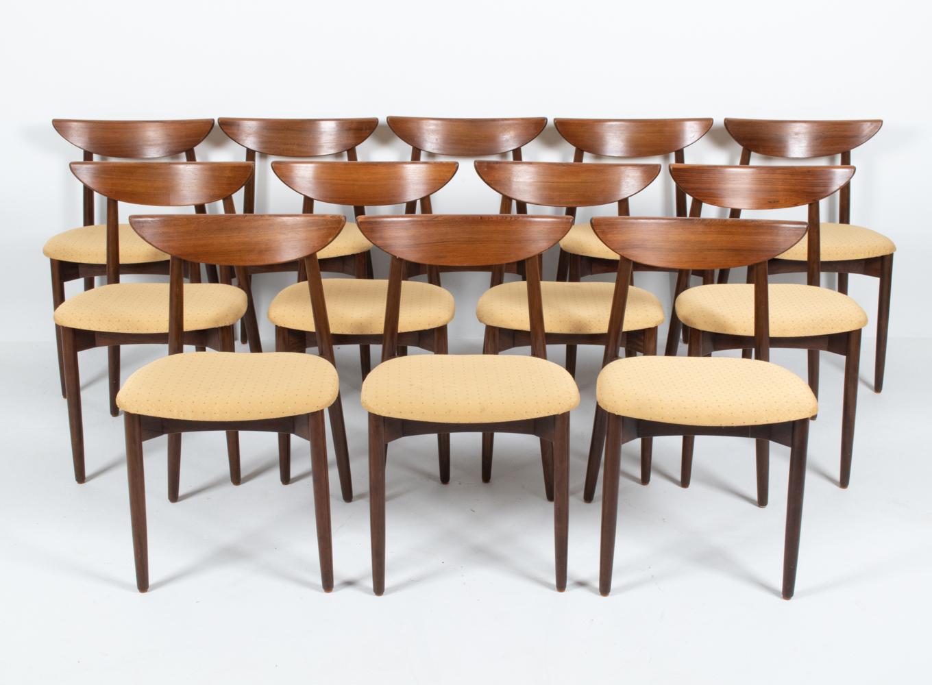 Impress your guests with this fabulous set of twelve rare dining chairs, designed by renowned Danish designer Harry Ostergaard. These model 58 dining side chairs are most identifiable by their iconic sculptural backrests, reminiscent of a crescent