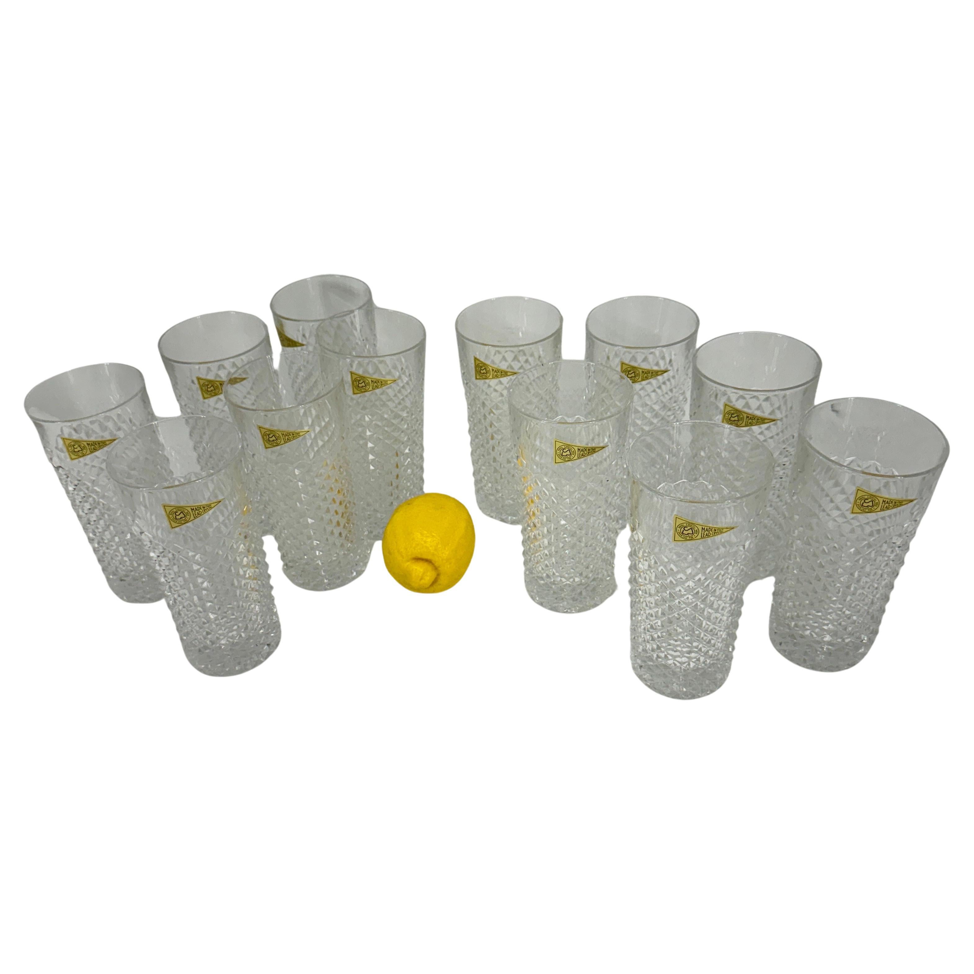 Set of 12 richly hand cut highball barware glasses, by Italian Royal Crystal Rock glassmaker. Each glass features deep cuts that allows the light to retract and shine to a brilliant finish from any angle.
Each glass is in very good condition.