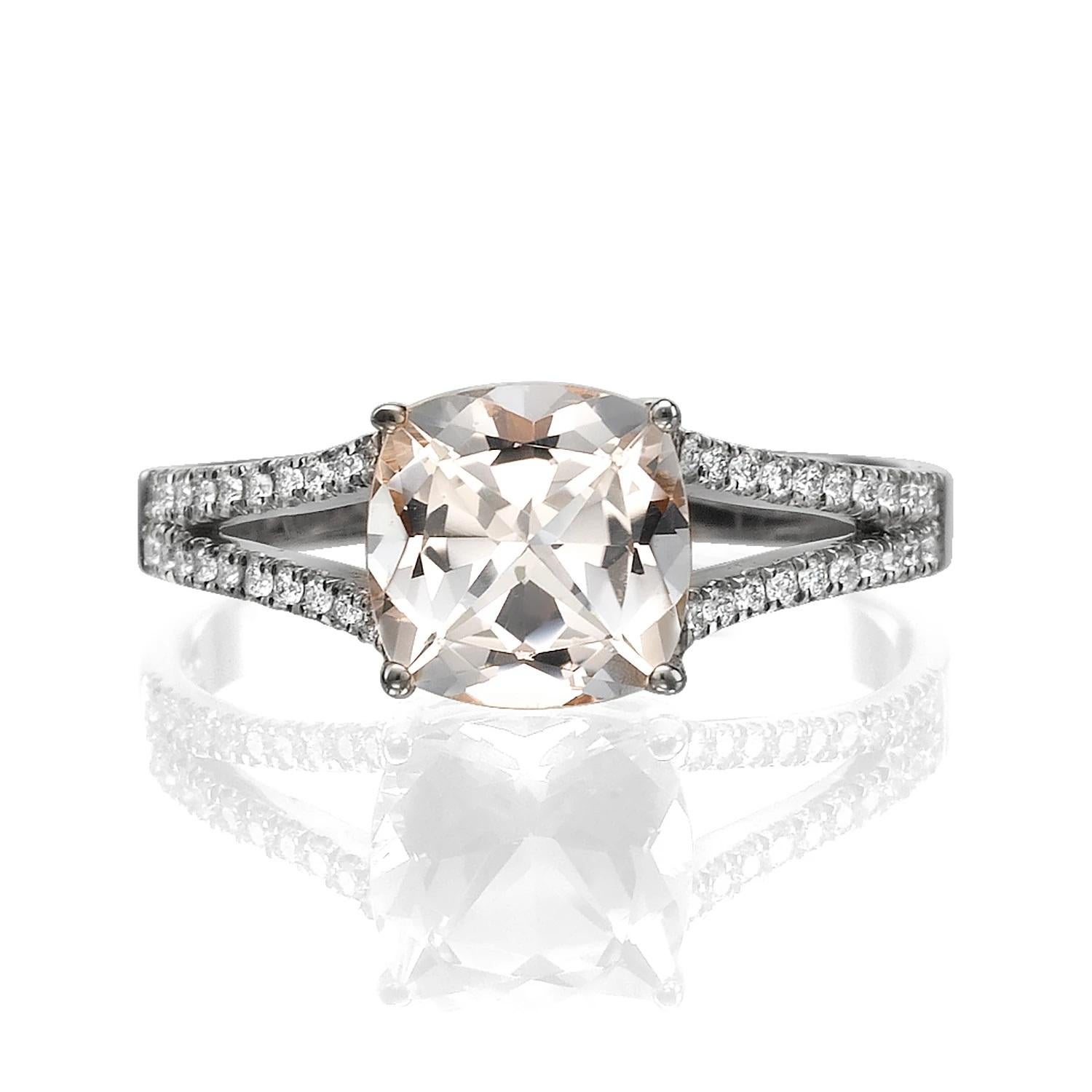 Unique split shank setting ring with beautiful morganite center stone and diamond side stones. Center stone is of 1 carat, natural, cushion shape, peach/pink color morganite and it is surrounded with 26 natural diamonds.
 
Main Stone Name: