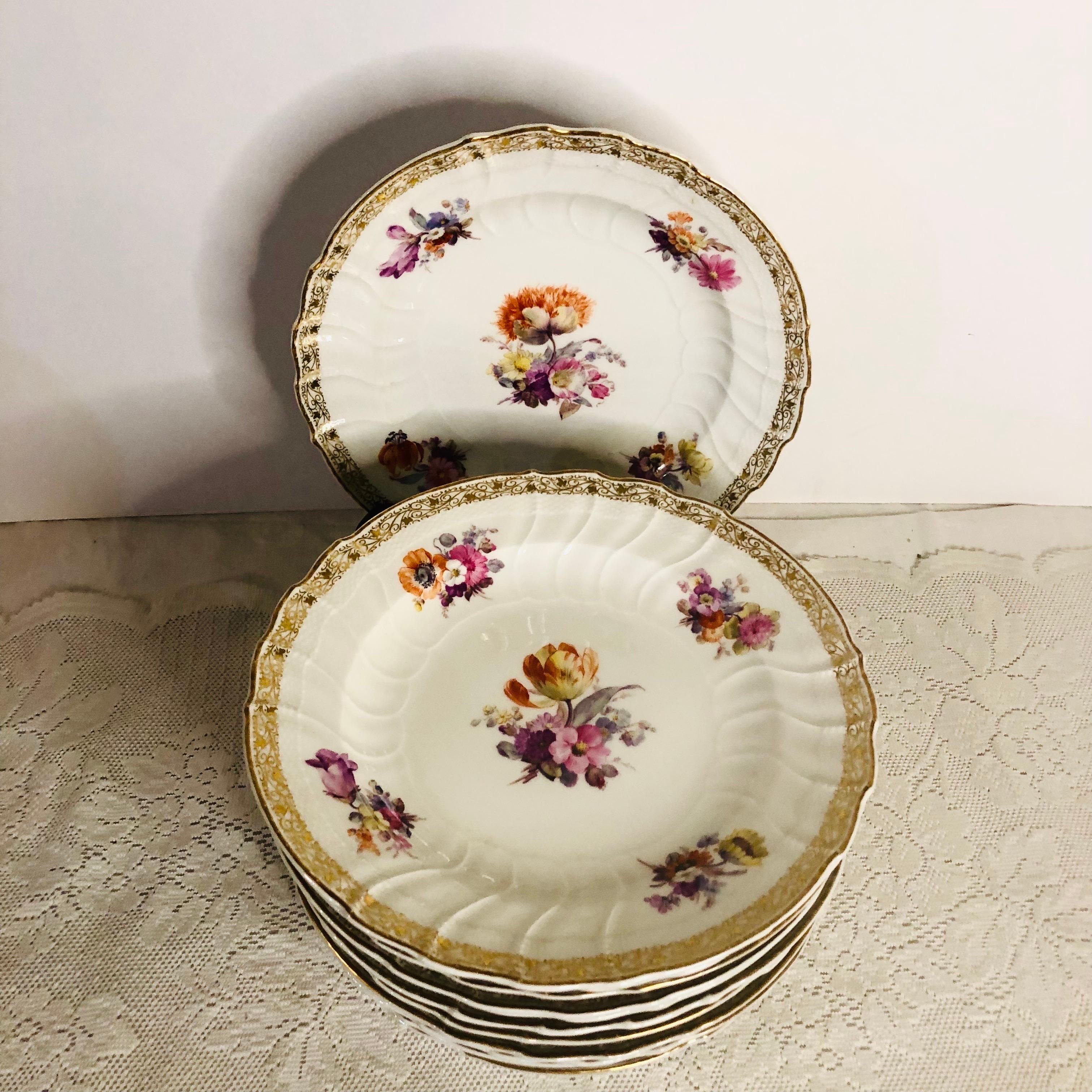 Set of twelve KPM dinner plates with different museum quality hand-painted floral bouquets on each plate. KPM is also known as the Konigliche Porzellan-Manufaktur of Germany. They had very talented artists who did an outstanding job of painting on