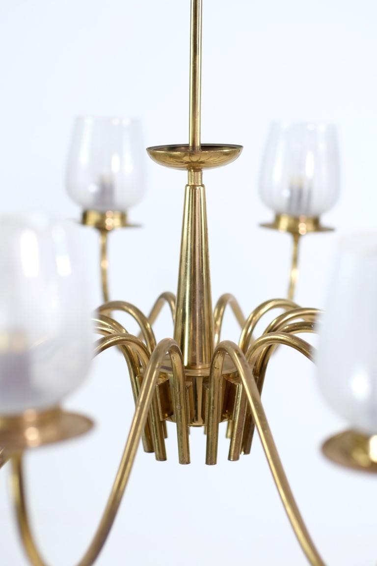 20th Century brass chandelier with sleek line arms mated with Italian hand blown glass shades. Chandelier bodies were made in Germany in the mid 20th century. This can be seen at our 333 West 52nd St location in the Theater District West of