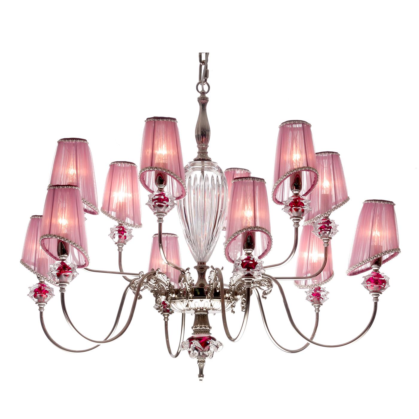 A perfect mix of majesty and refinement characterizes this 12 lights chandelier in pink shades. A play of lights and reflections, thanks to the rounded lines and the arrangement of the 12 arms. This chandelier adapts perfectly to a traditional and