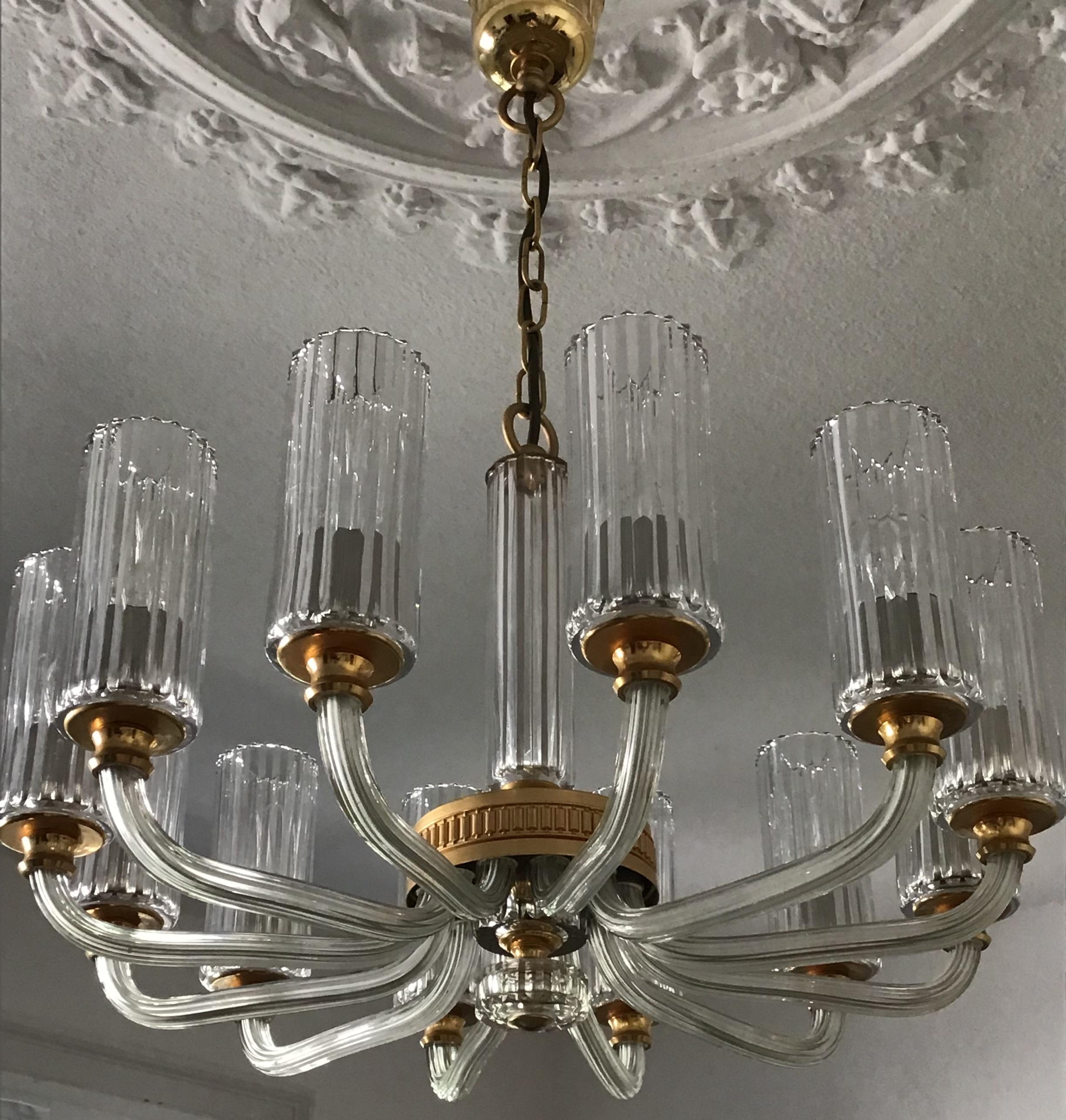 Very elegant, high quality 12- arm crystal and gold -silver plated brass chandelier,  Italy, circa 1980s.
The condition is excellent.