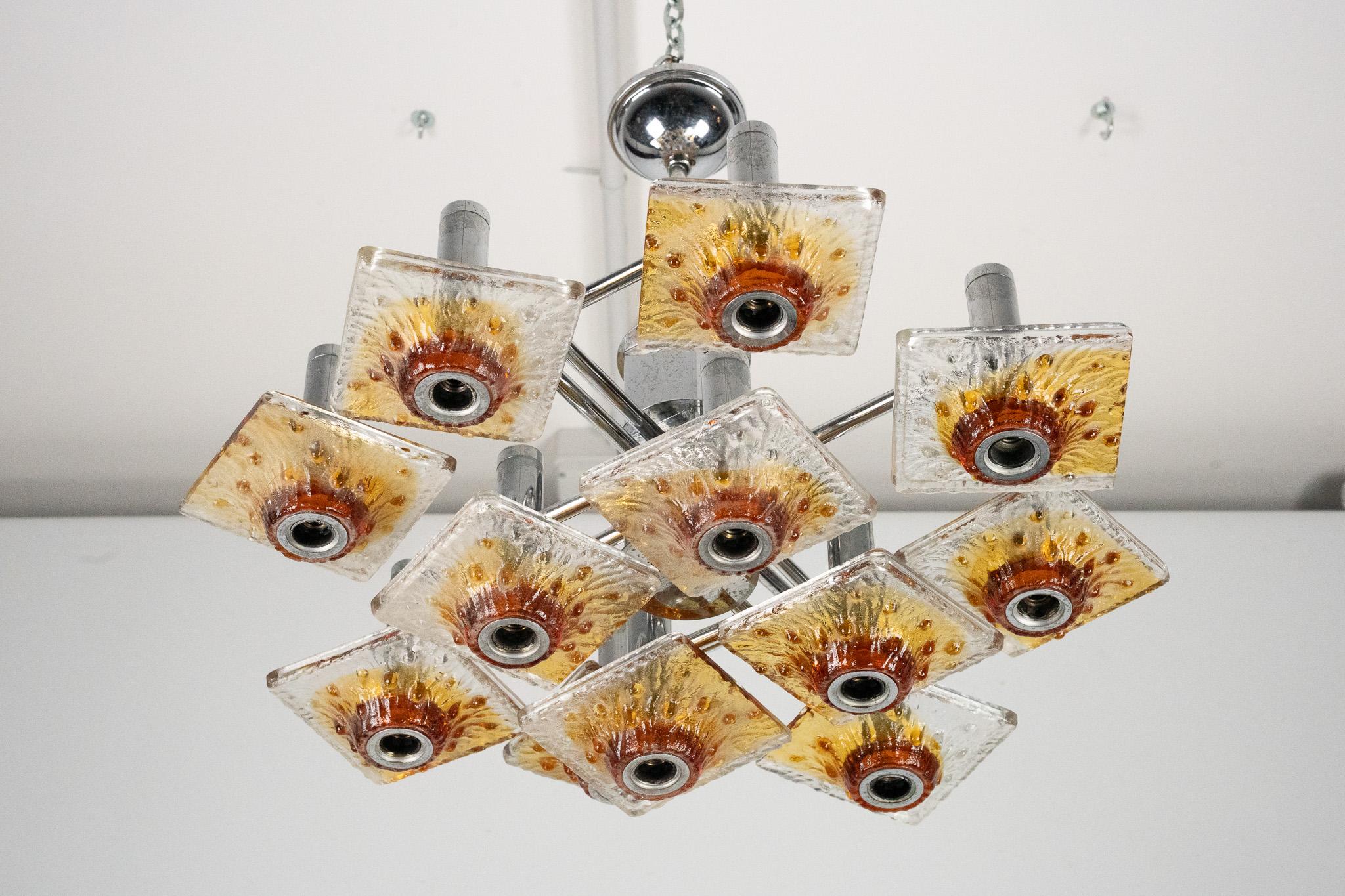 Mid-Century Modern 12-light Mazzega chandelier in amber and clear murano glass and chrome. Italy 70 For Sale