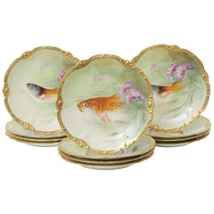 12 assiettes à poisson de Limoges, peintes à la main et signées par l'artiste, anciennes, circa 1890