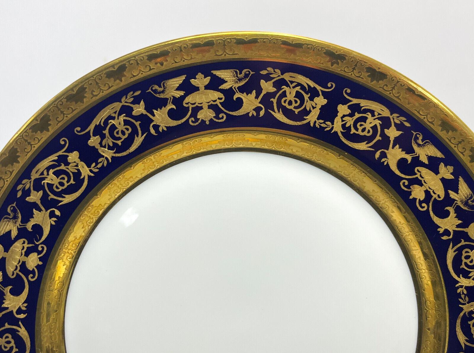 12 Limoges Raynaud porcelain dessert or salad plates in Pompei. A cobalt blue ground with rich gilt birds and foliate scrolls.The “bleu de four” motifs taken from a sumptuous antique vase are hand-enhanced with fine gold.  Limoges Raynaud mark to