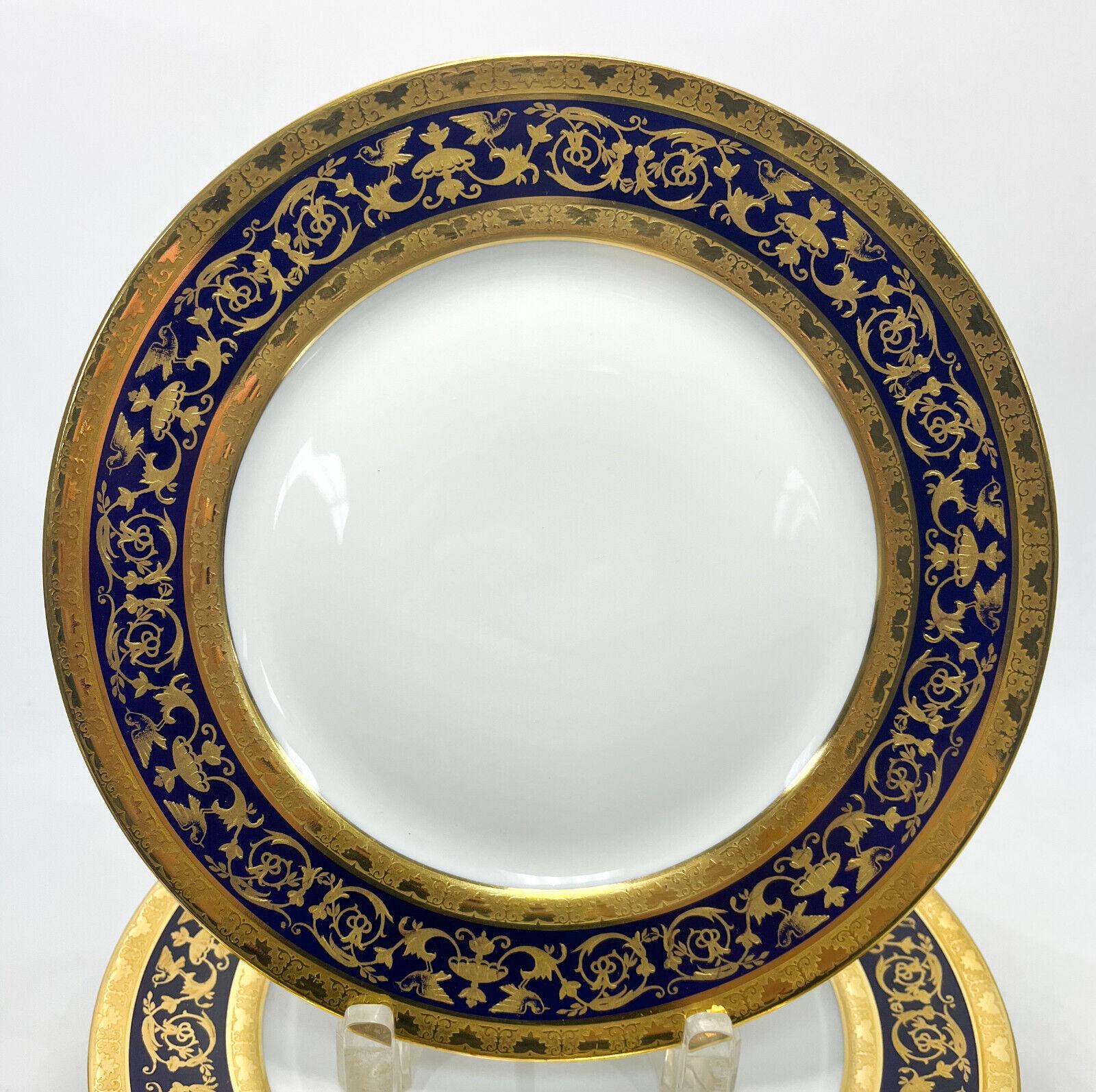 12 Limoges Raynaud porcelain dinner plates in Pompei. A cobalt blue ground with rich gilt birds and foliate scrolls.The “bleu de four” motifs taken from a sumptuous antique vase are hand-enhanced with fine gold.  Limoges Raynaud mark to underside.