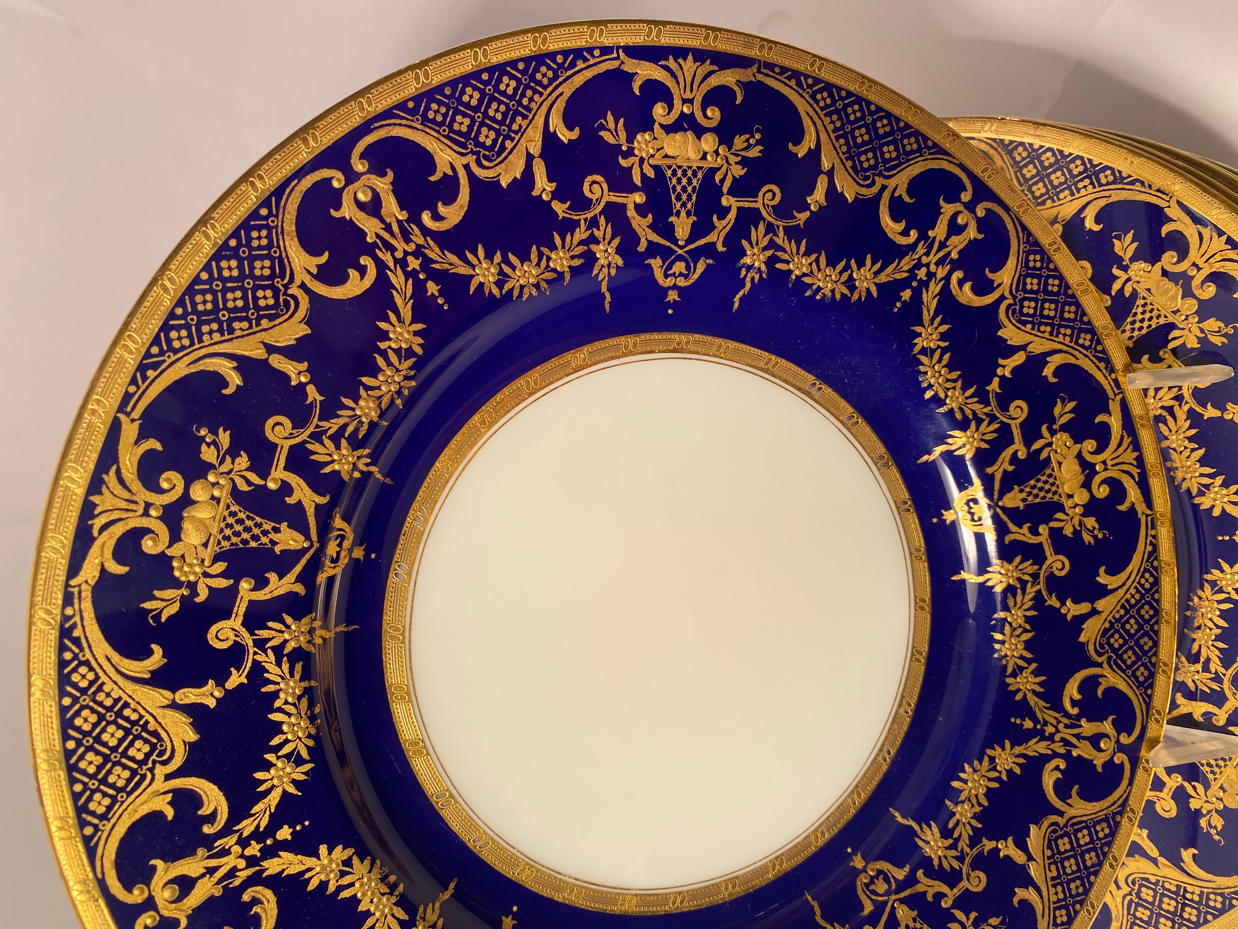 From the storied Gilded Age firm of Minton, England we have 12 elegant cobalt blue with raised gilding plates that were custom ordered through the retailer Davis, Collamore and Company New York. The plates are in very good antique condition and will