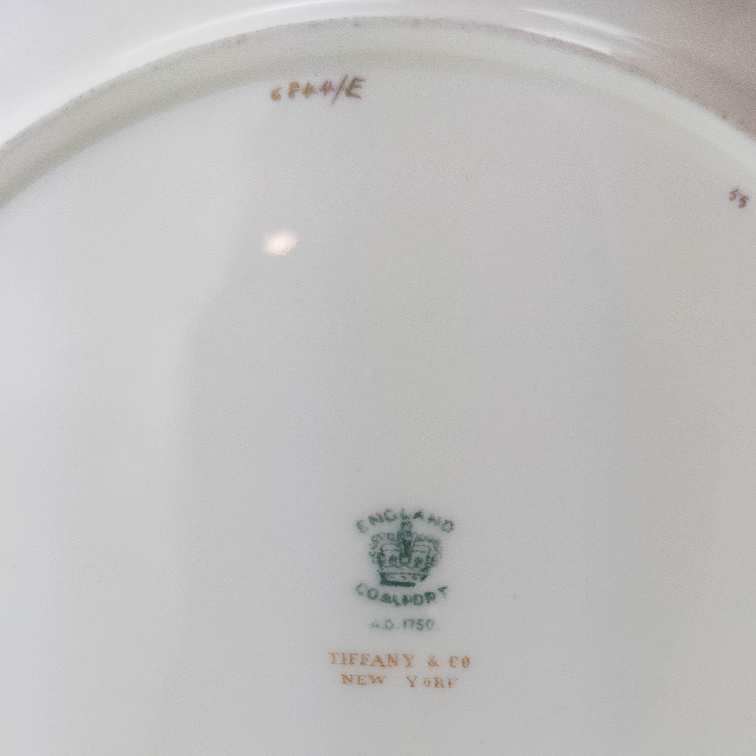 From the storied firm of Minton, one of their timeless and classic designs. This plate features a white and soft cream combination ground with a 24-karat gold encrusted outer band. One of the most versatile patterns and will mix and match in nicely