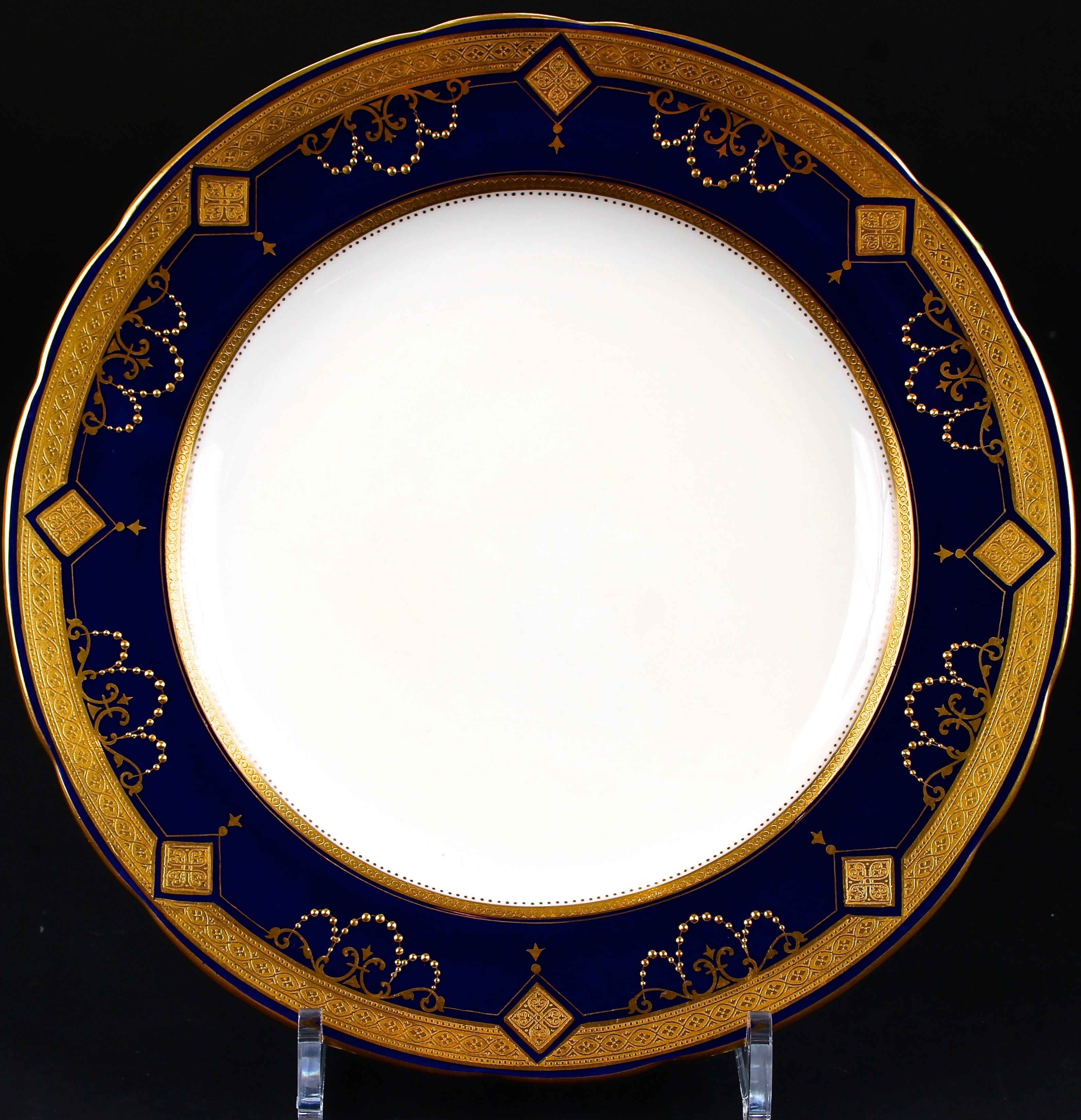These 19th century Minton, Stoke-on-Trent, England, cobalt medallion plates feature 22-karat gold acid-etched in the inner and outer border with gold encrusted medallions interspersed between swags and gold beading. The edge design is 