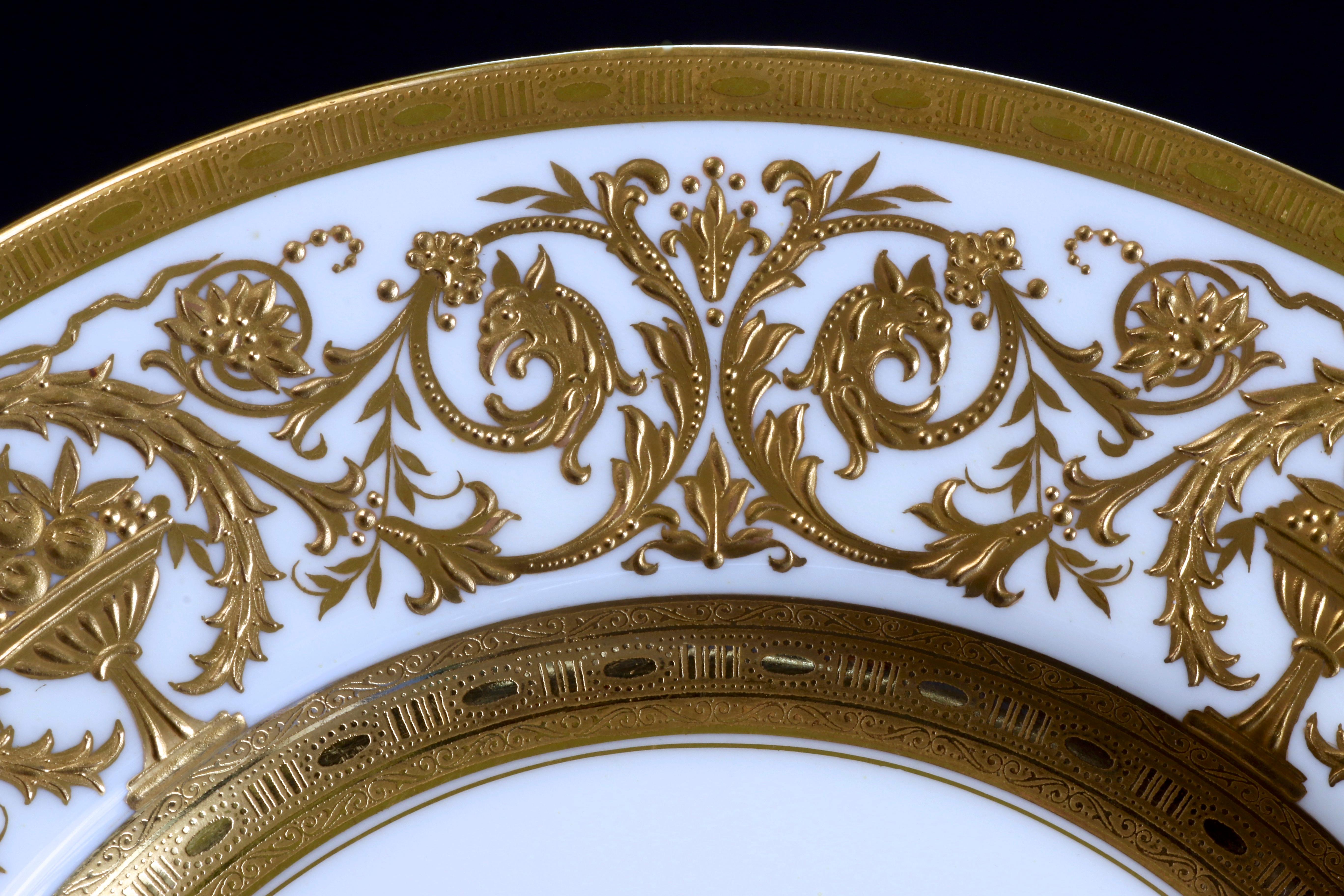 The 12 custom gilded dinner plates offer some of the finest gilding we at Gilded Age Dining have ever had the pleasure to examine. The gold is extremely thick, there is so much gold on these plates that they are quite heavy, a single plate weighs 18