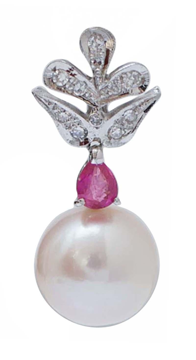 Amazing earrings in platinum structure mounted with diamonds in the upper part; in the middle, a ruby and, as pendant, a pearl.
These earrings were totally handmade by Italian master goldsmiths and they are in perfect conditions.
Diamonds 0.39