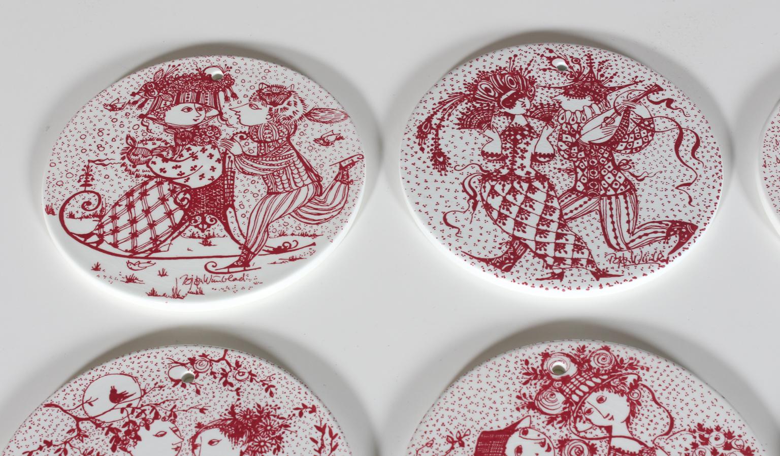 A complete set of 12 beautiful red and white wall plates, designed by Bjorn Wiinblad for Nymolle Denmark, 1970s. 

Each of these plaques represents a month. They display the charming story of a young couple from falling in love in January, getting