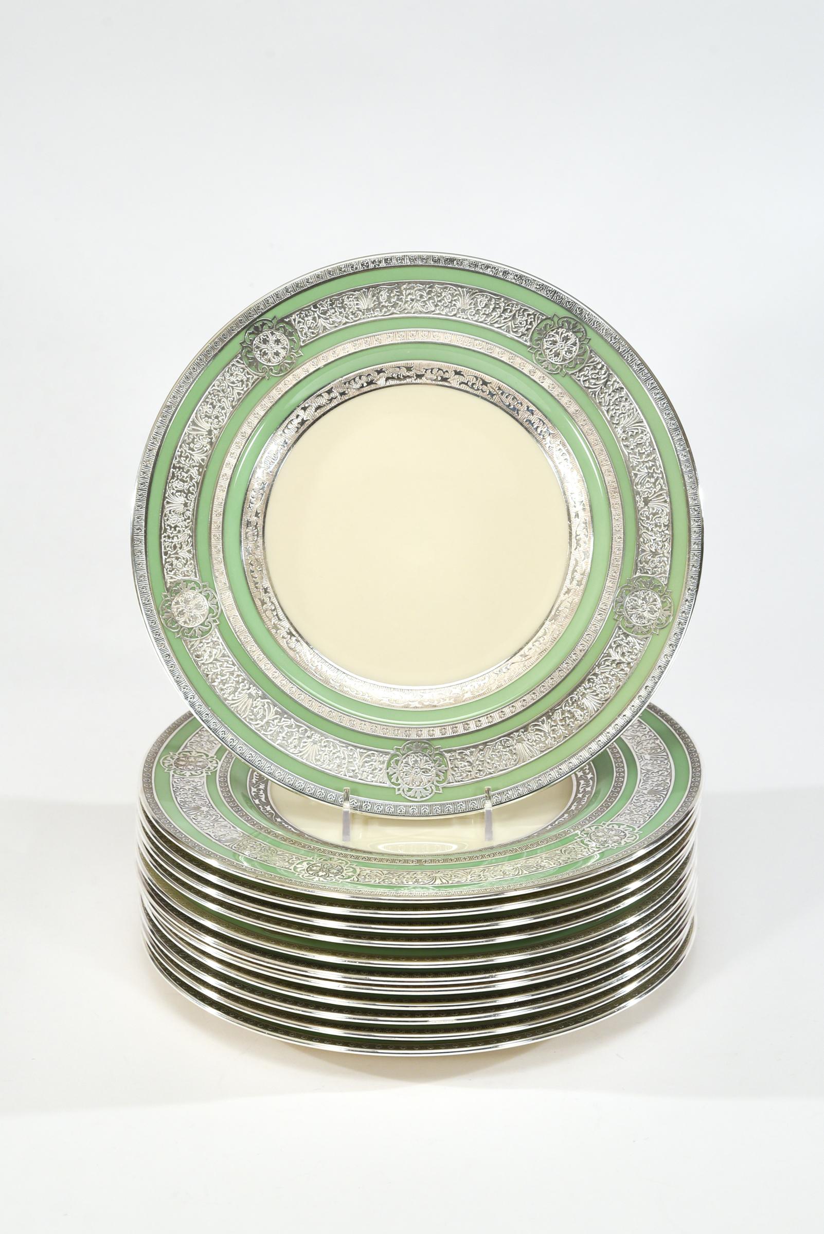 This set of 12 Morgan Belleek dinner plates are decorated with four gorgeous filigree silver overlay bands which frame the green border and ivory centers. These are true showstoppers, their 10 3/4