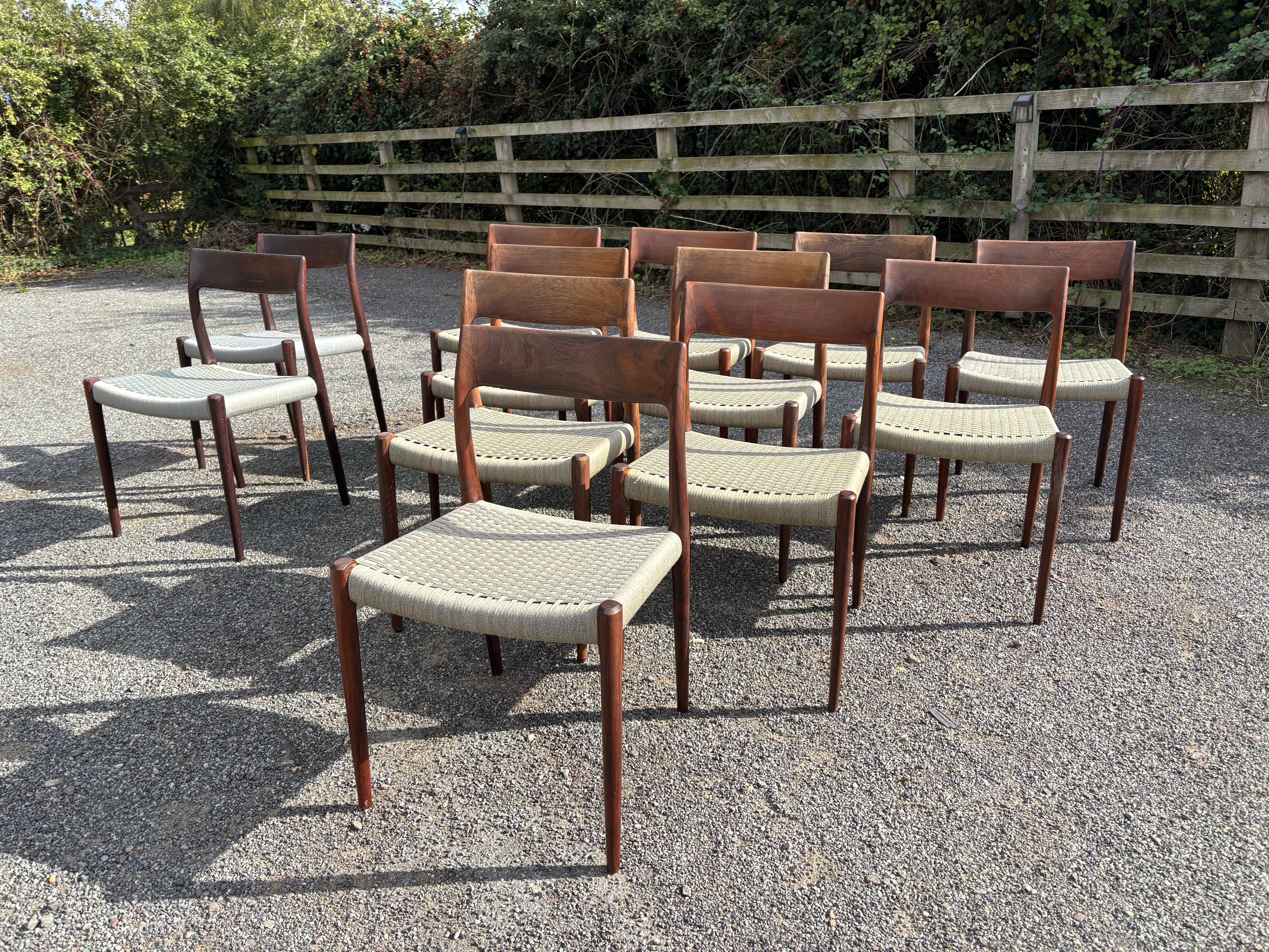 These twelve dining chairs by Niels Otto Moller with original cord (10 in khaki/beige woven cord seats and 2 in lavender cord seat)  have round labels, meaning they were made  between 1958 and 1969. 

Some minor stains and marks on seats but largely