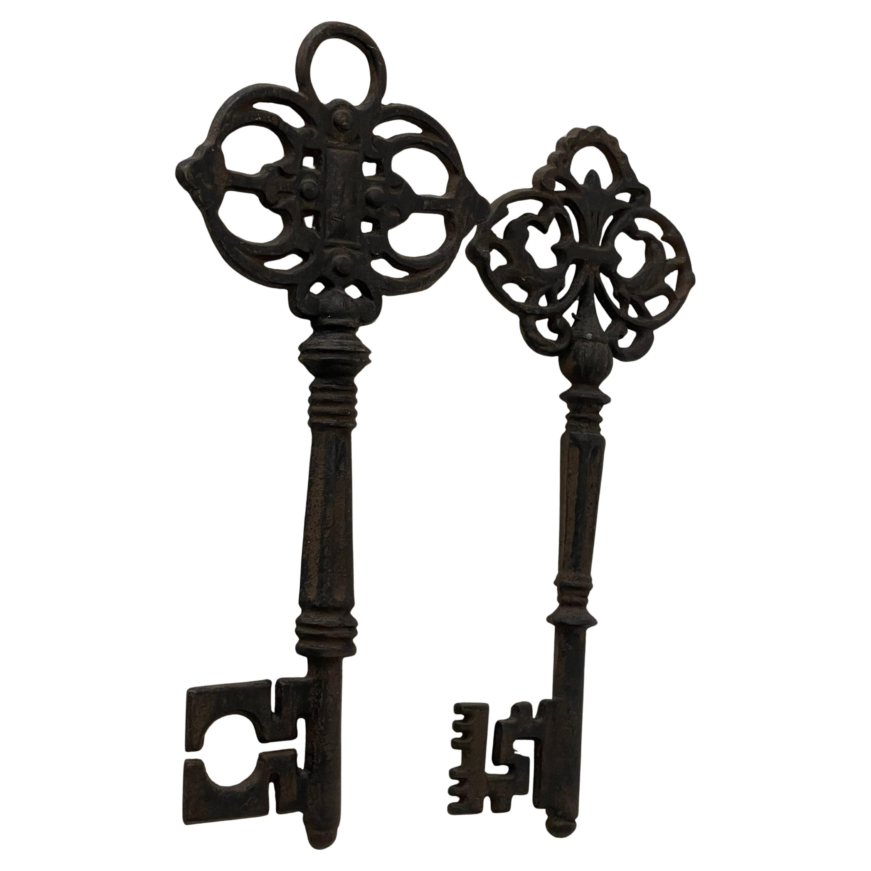 Pair if vintage 12” long cast iron baroque style keys with fluffy tassels.Wall decor accents.