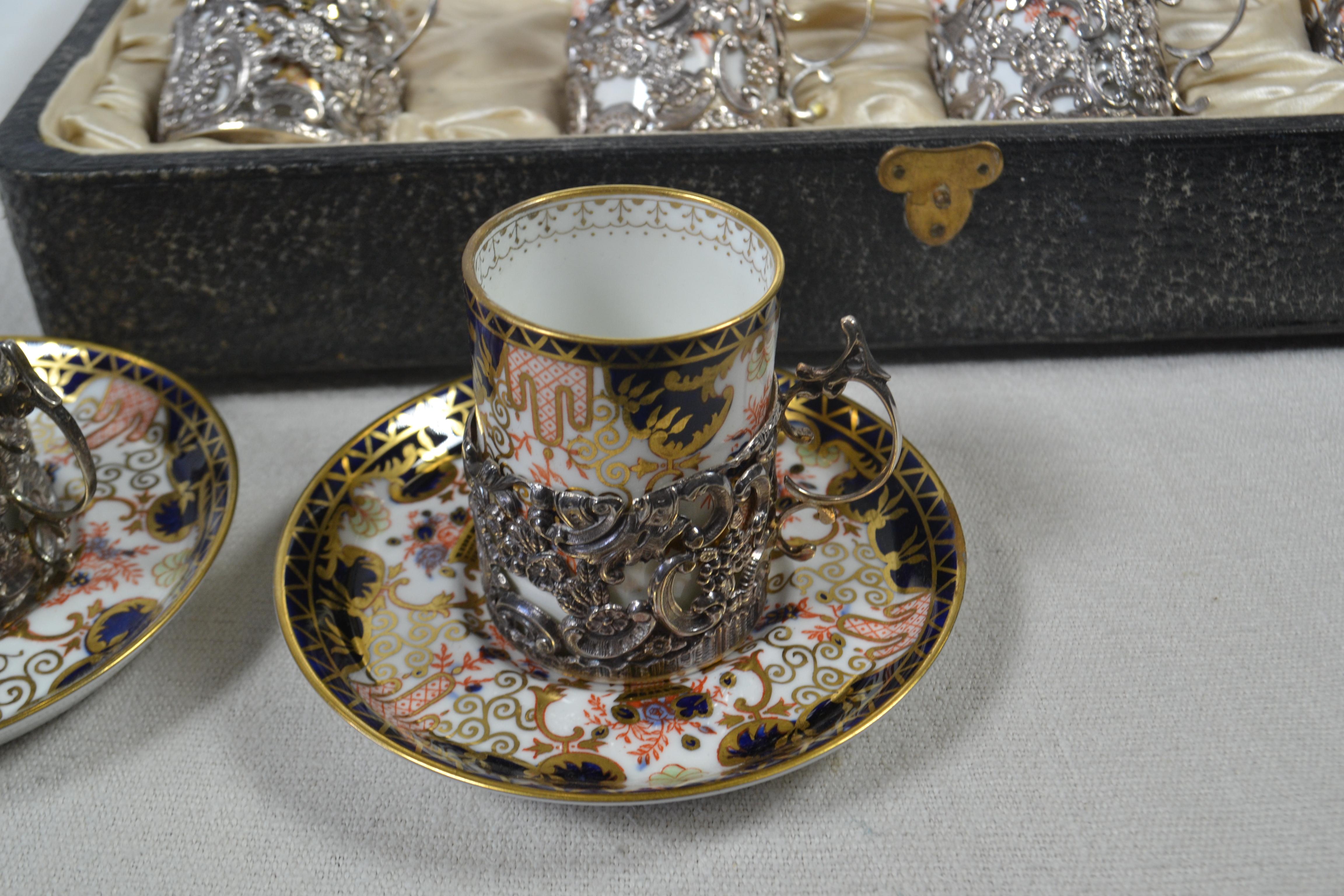 12-piece blue, white and multi color bone china Royal Crown Derby 3788 antique coffee service with ornate floral and geometric motif throughout, gilt trim and brand stamp at undersides. Includes 6 Royal Crown Derby flat cups, 6 Royal Crown Derby
