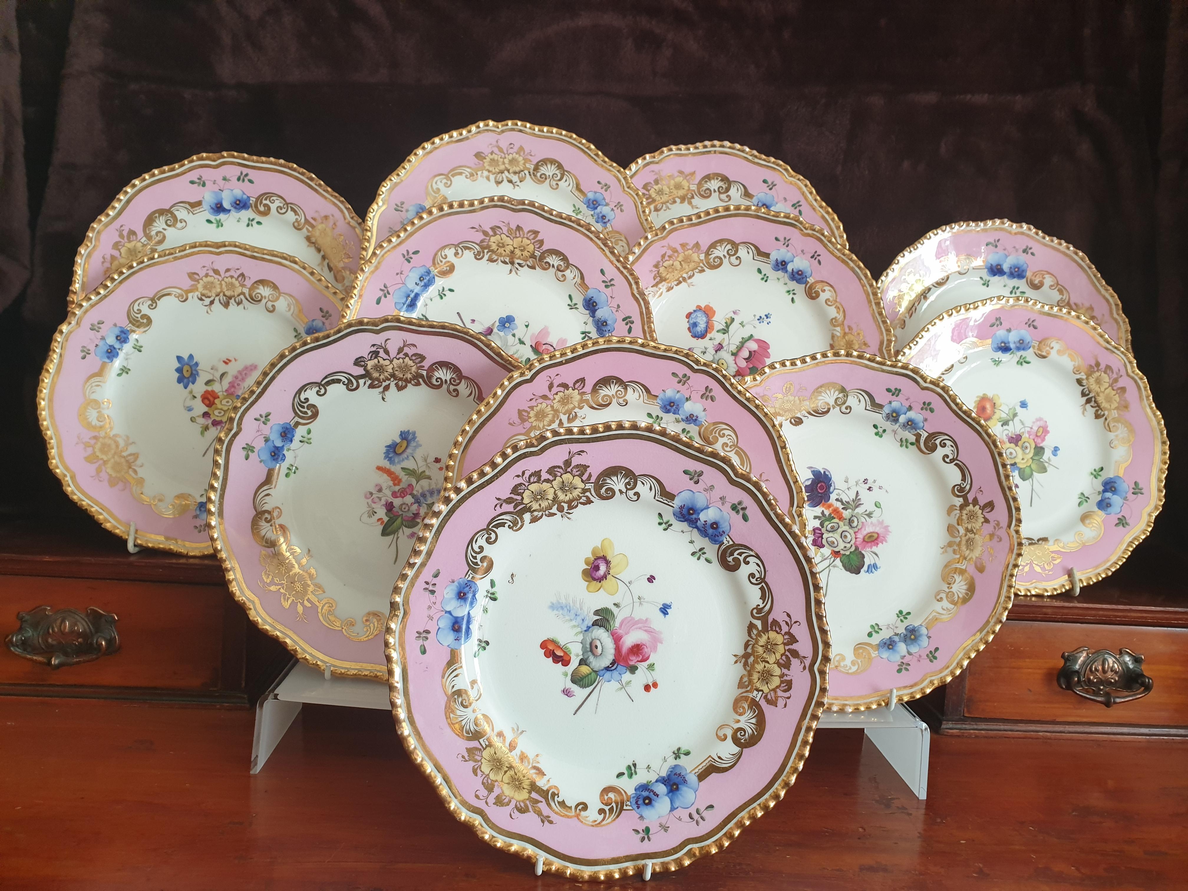 A Coalport set of 12 absolutely gorgeous pink dessert plates all hand painted pieces attributed to Steven Lawrence, one of the best painters from the factory.  These plates are In excellent condition and dates circa 1820's. 
Each plate is hand