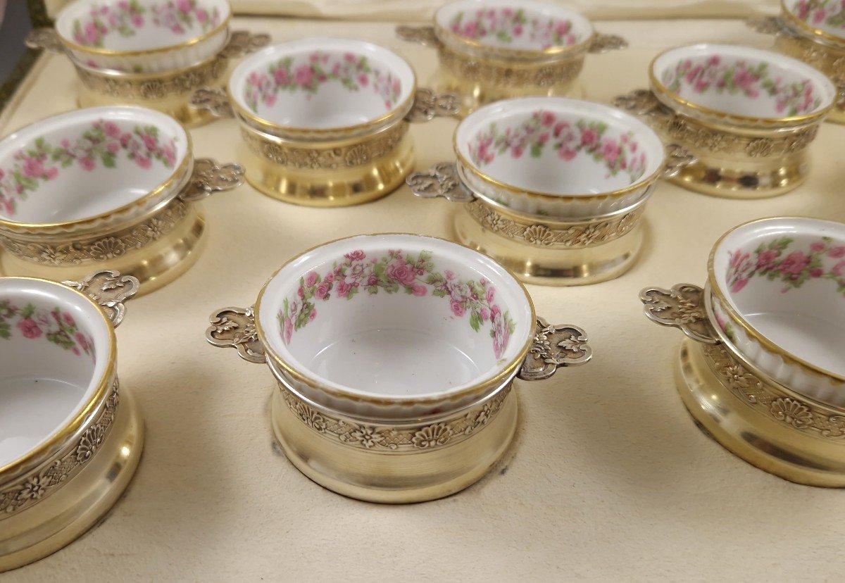 Set of twelve porcelain ramekins decorated with flowers, the mounts in Sterling Silver gilt decorated with shells and rosettes 
Minerva hallmark 1st title for 950/1000 purity silver
French work circa 1880
Length 9.6 cm
Diameter: 6.6 cm
Height 3.5