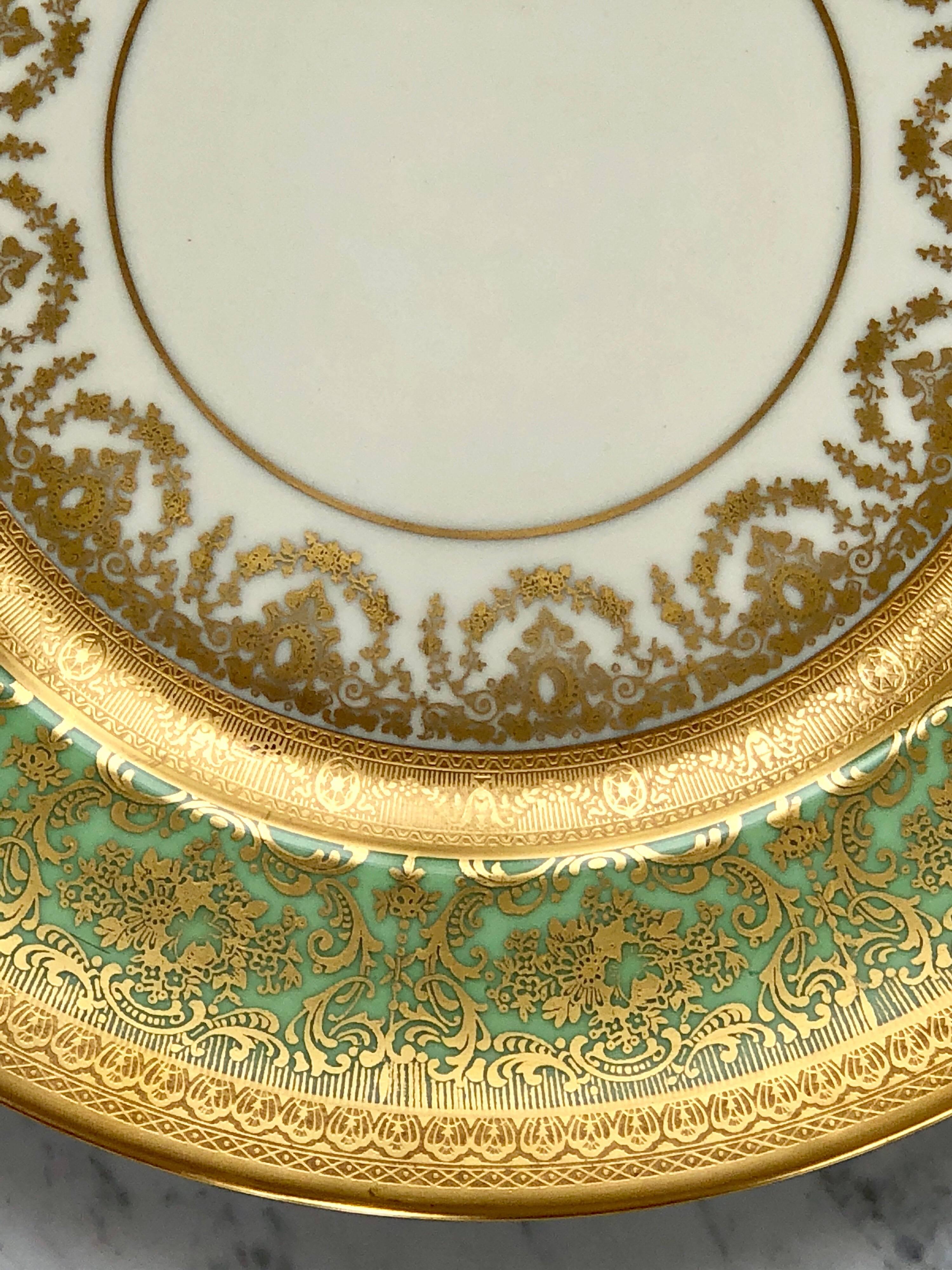 An exquisite set of 12 dinner plates by Heinrich Selb &Co. The very ornate 24-karat gold decoration of flower garland's and the intricate foliate designs on a light green and ivory background make them perfect choice for festive occasions.
Made in