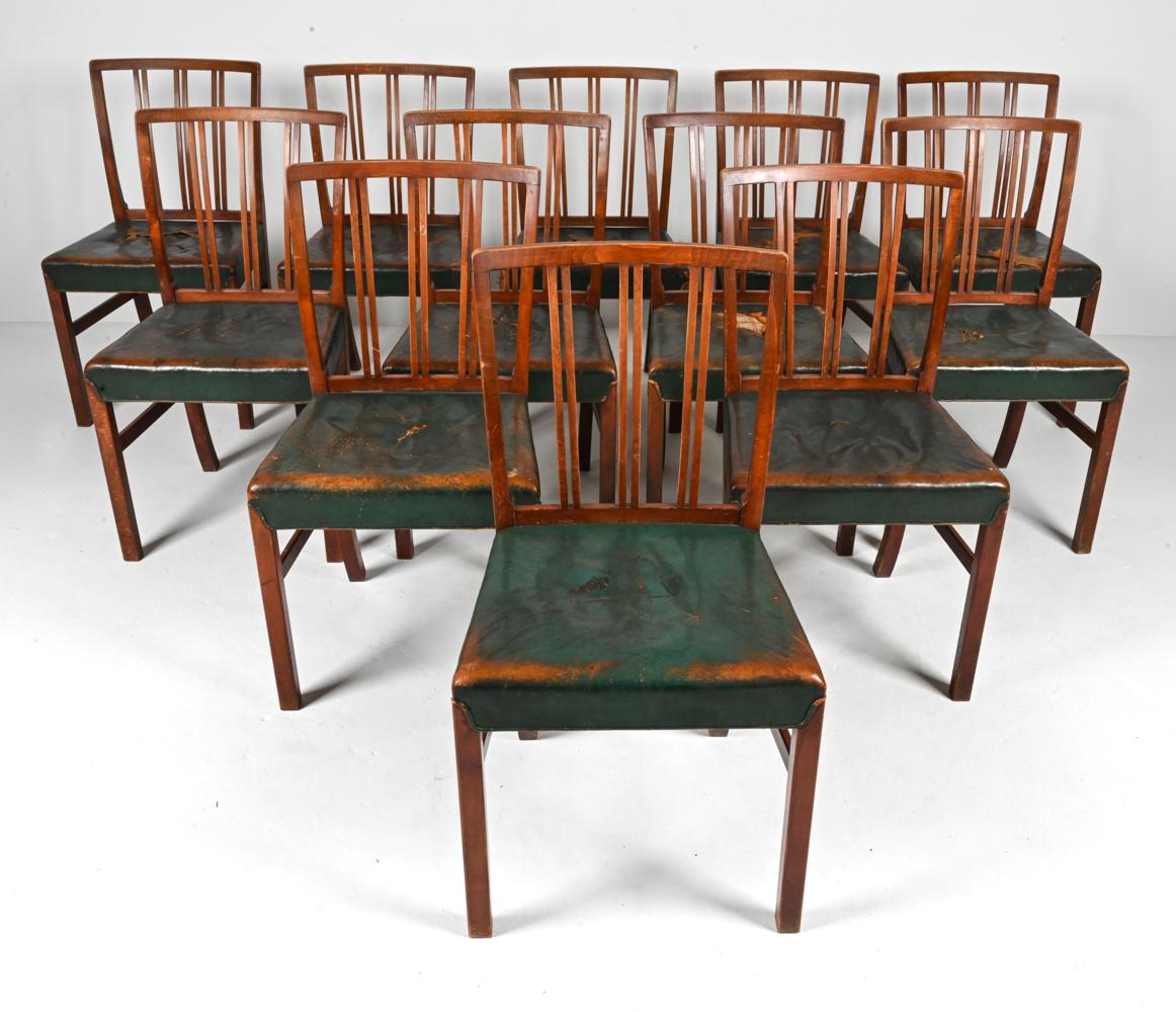 Presenting a rare and distinguished set of twelve side chairs from the 1675 series, designed by the visionary Ole Wanscher and expertly crafted by Fritz Hansen in the 1940's. With their timeless elegance and enduring charm, these chairs are a