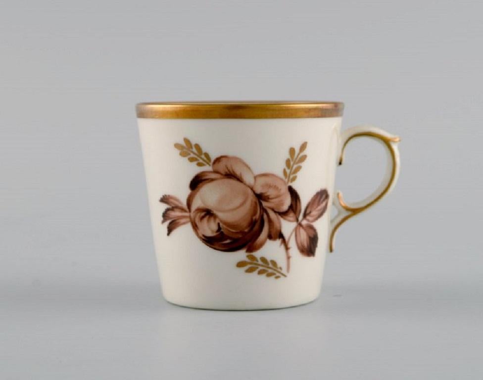12 Royal Copenhagen Brown Rose mocha/coffee cups with saucers in hand-painted porcelain with flowers and gold edge. 
Dated 1968.
The cup measures: 6 x 5.5 cm.
Saucer diameter: 11 cm.
Stamped.
In excellent condition.
1st factory quality.