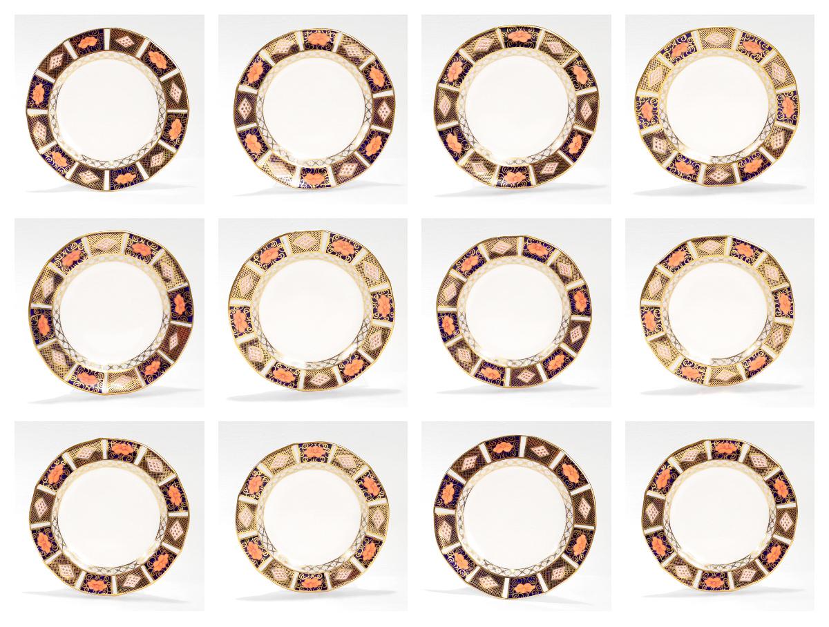 A fine set of 12 Royal Crown Derby porcelain bread & butter plates.

In the Border Imari pattern (No. 8450).

Consisting of 12 plates all with scalloped rims, gilt highlights, and imari designs to their borders.

Marked to the base of each with the