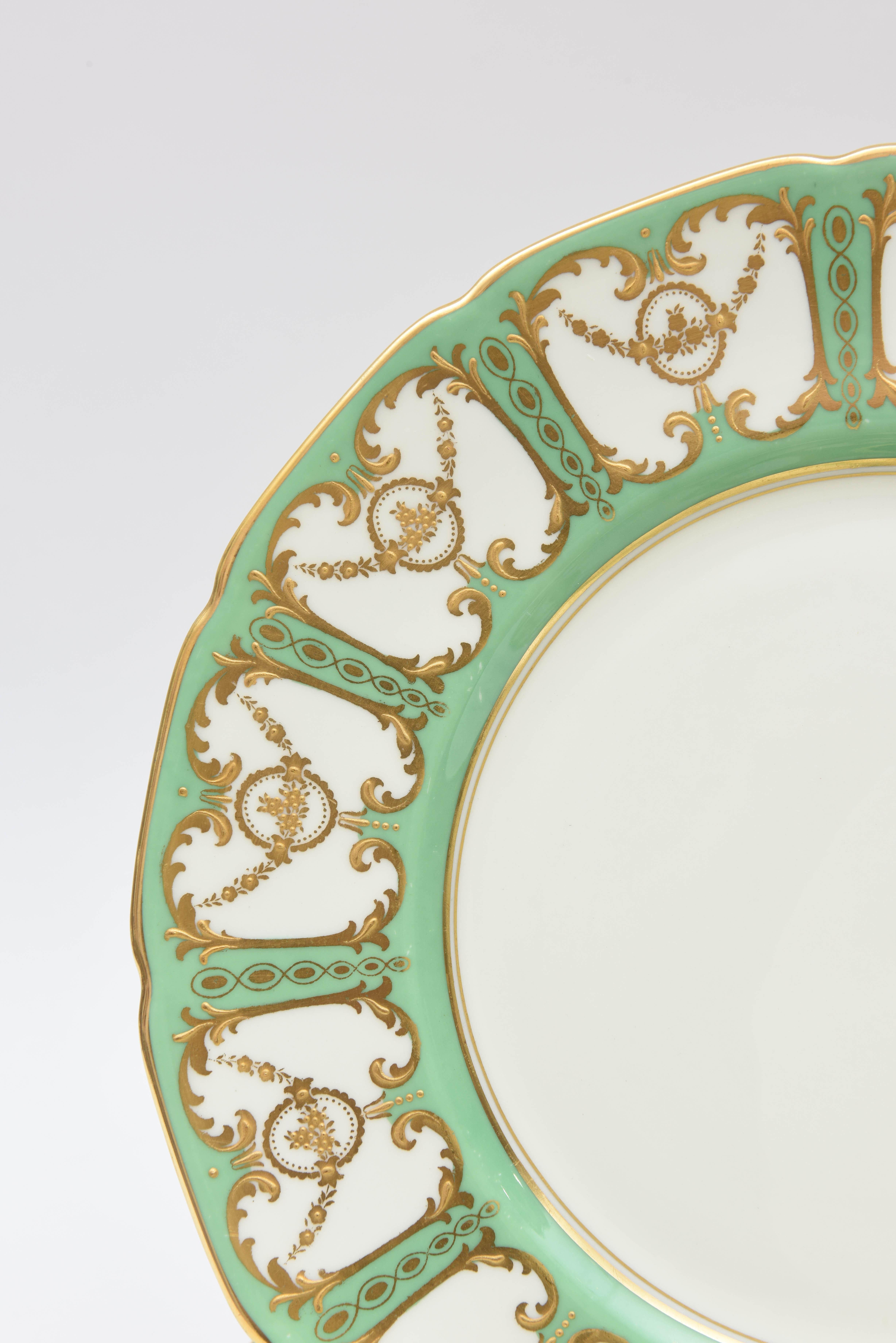 One of our favourite makers and colors, this great set of Royal Doulton England Porcelain plates feature cartouches of raised gilt foliate swag on the collars of the plates in a soft Sevres Green ground. Perfect for mixing and matching in with all