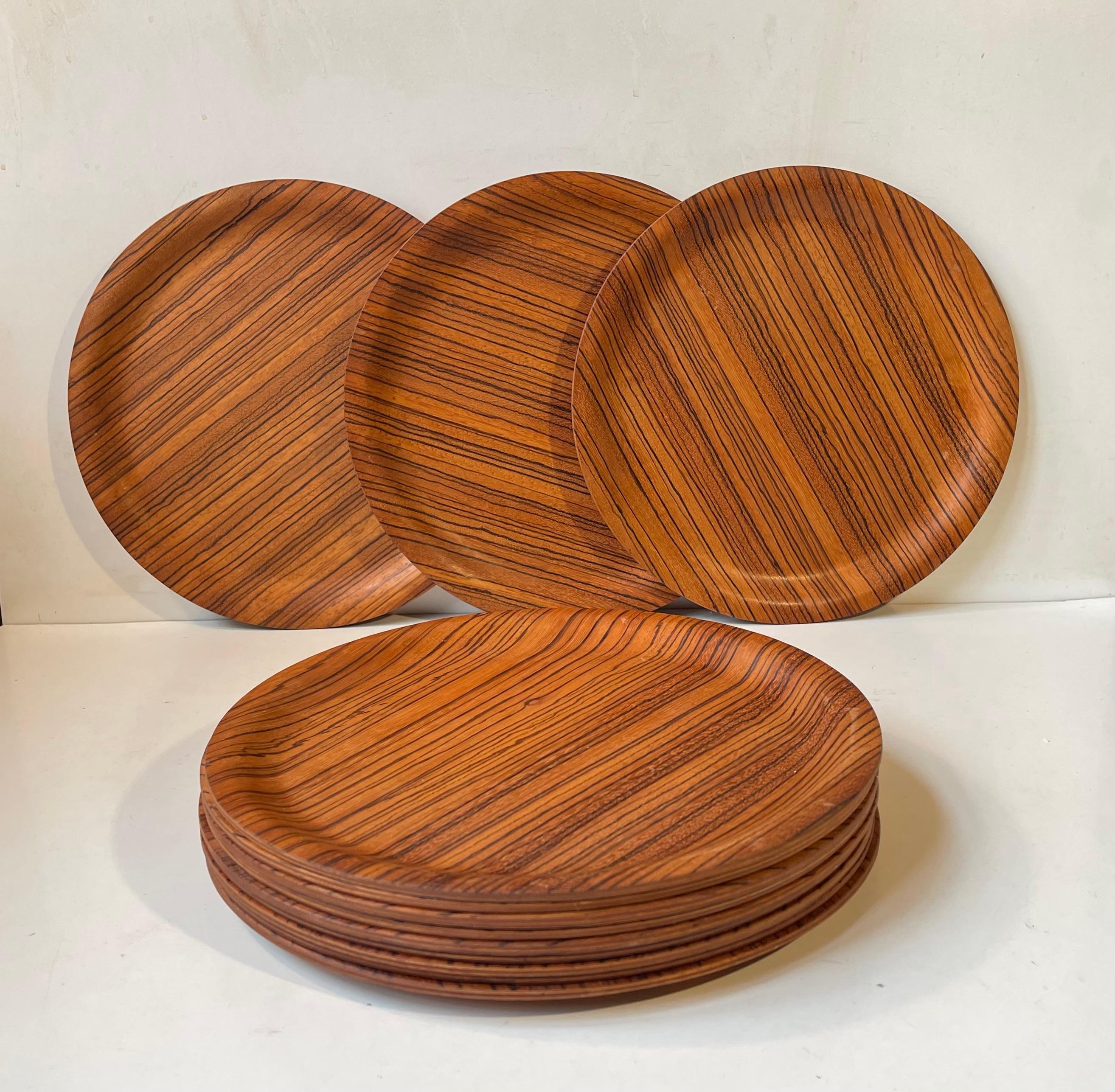 A complete set of 12 plates or cover plates made from zebra wood (Astronium graveolens). The plates were possibly commissioned by Illums Bolighus in Copenhagen and designed by Laust Jensen in the mid 1960s. This however remains unproved.