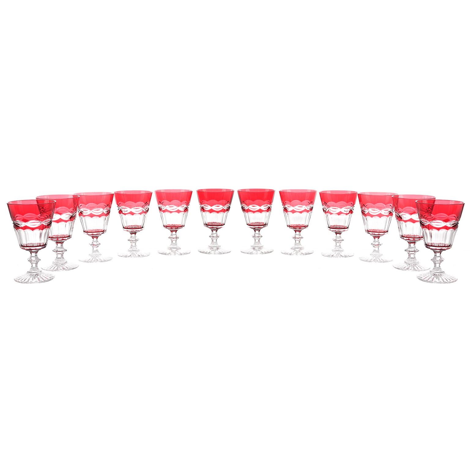 St. Louis, France, circa 1920s. These 12 crystal goblets by the legendary Saint Louis of France are beautiful. Perfect for everyday or entertaining and just right for water or wine, the bright cranberry color flawlessly completes the visual