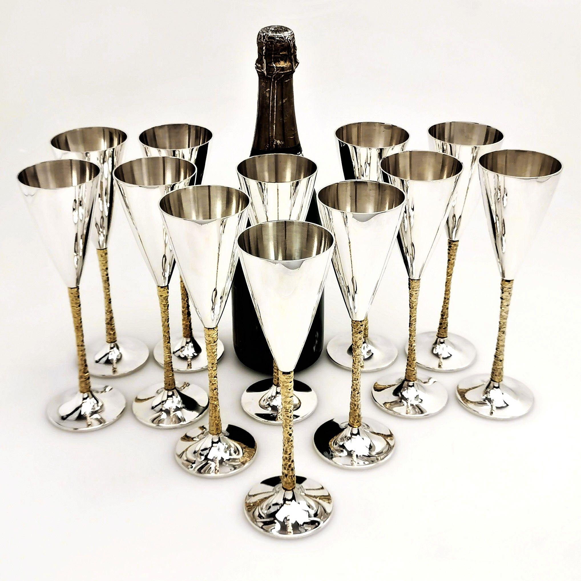 A set of 12 Classic Stuart Devlin Champagne Flutes featuring his Iconic parcel gilt faceted stems and highly polished flutes and bases.
This set of Champagne flutes was made by Stuart Devlin between 1977 and 1980.
 
 Approx. Total Weight of Set -