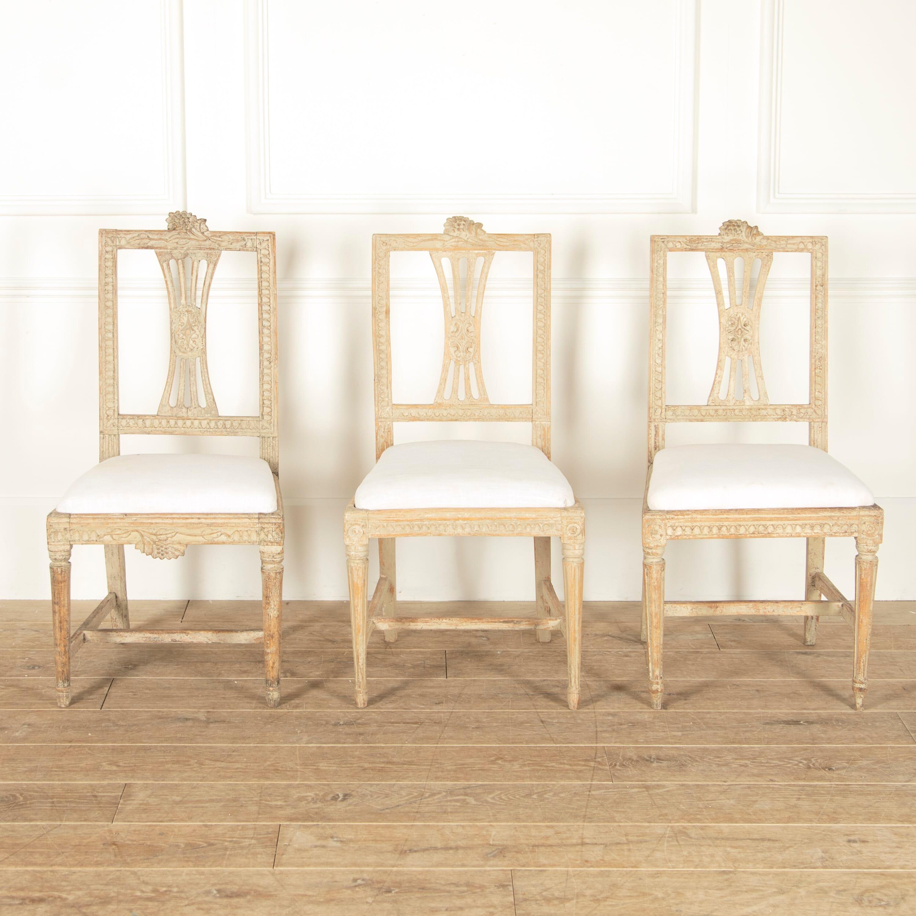 Matched set of 12 19th century dining chairs from the Lindome area of Sweden, Circa 1830-1850.

These lovely chairs embody a classic Swedish design, with their refined and rectilinear form adorned with extensive carving to the frames. 

This set