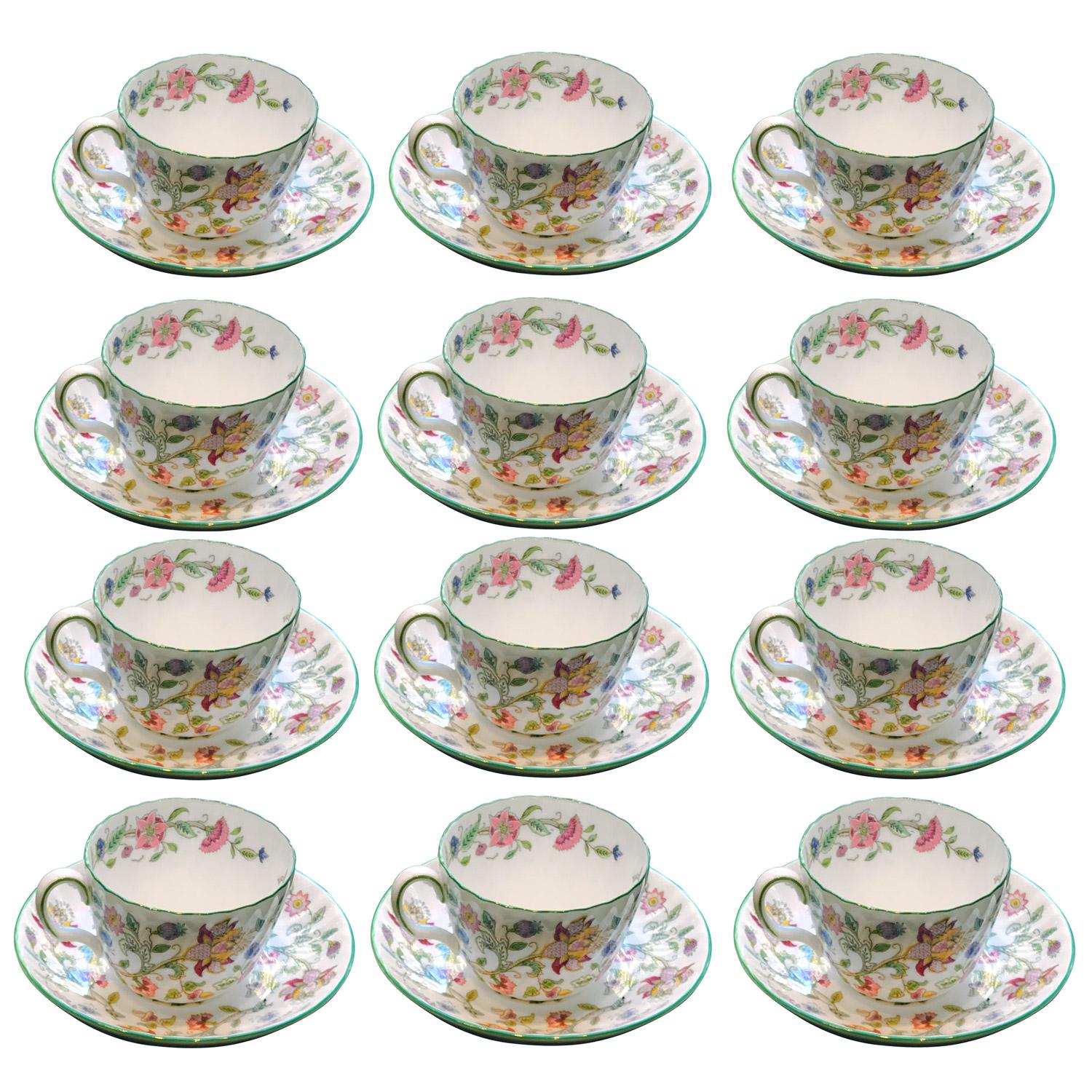 Set of 12 teacups and with their saucers in Minton Bone China Porcelain. Famous Minton Haddon Hall model designed by John William Wadsworth (1879–1955), recognizable with its fluted body and white background decorated with colorful flowers such as