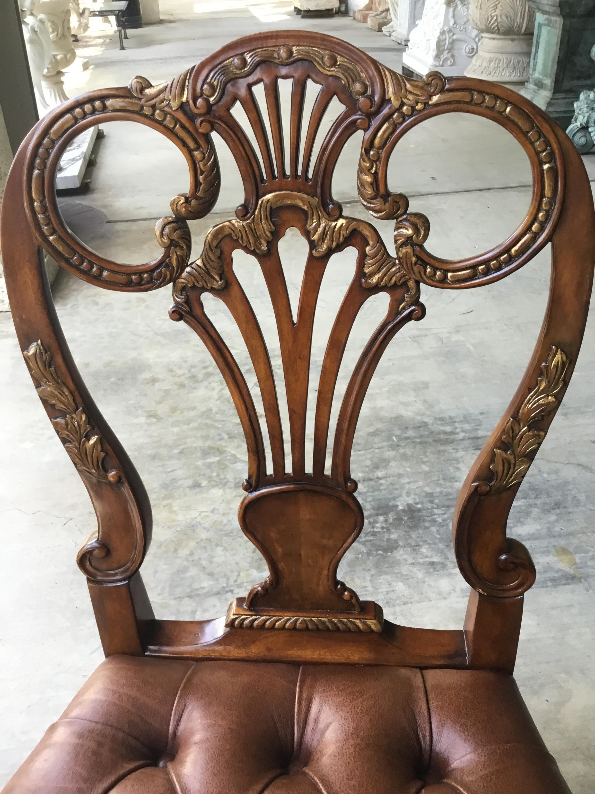 Set comprised of two arm chairs and ten side chairs. Each
Having finely carved splat backs and shaped crest rails.
The front legs of cabriole form with acanthus leaf carved knees
And whorl feet. Button tufted leather upholstered seats with brass