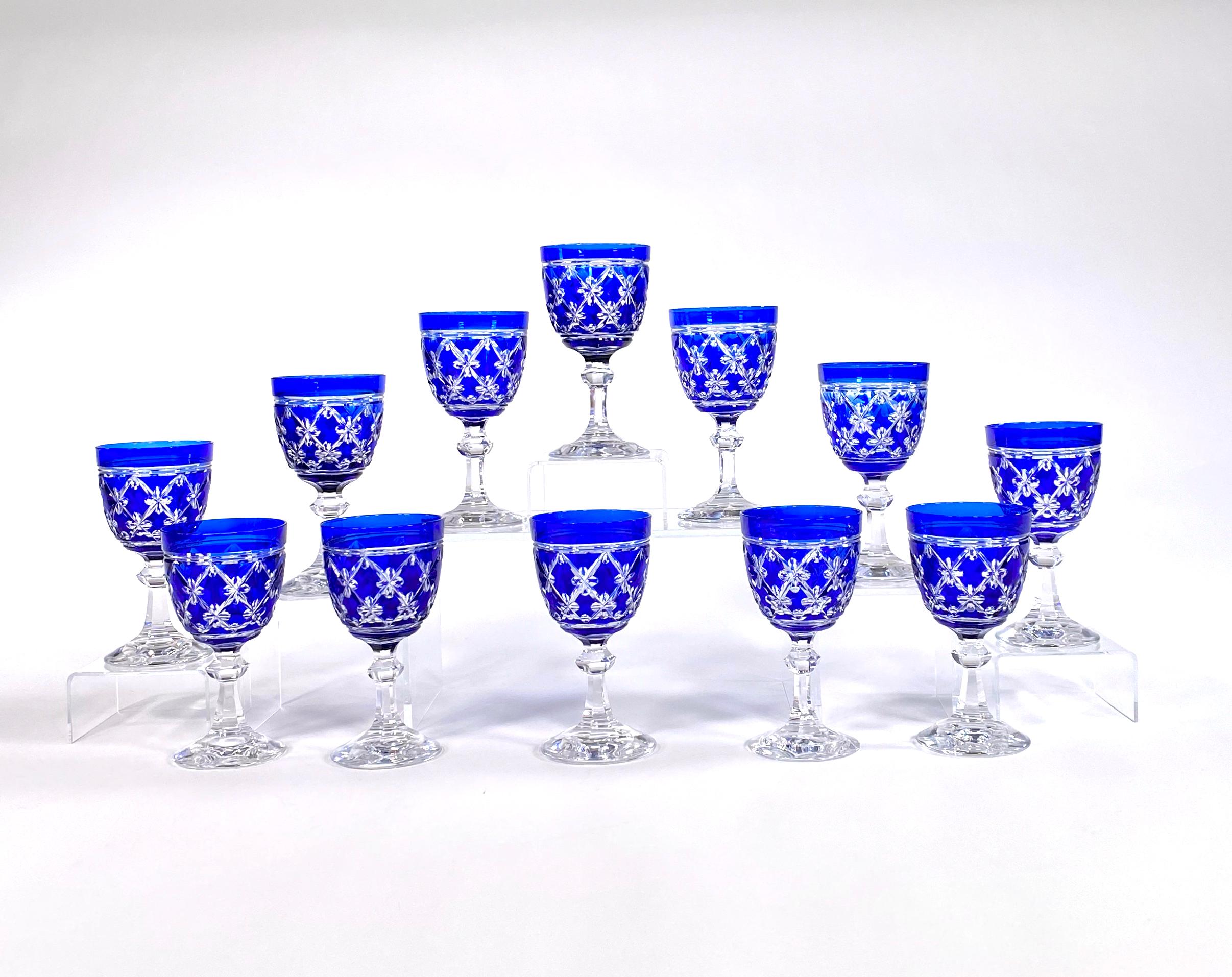 One of Val Saint Lambert's most sought after patterns, this set of 12 water or wine goblets is hand blown crystal with cobalt blue overlay and cut to clear in the 