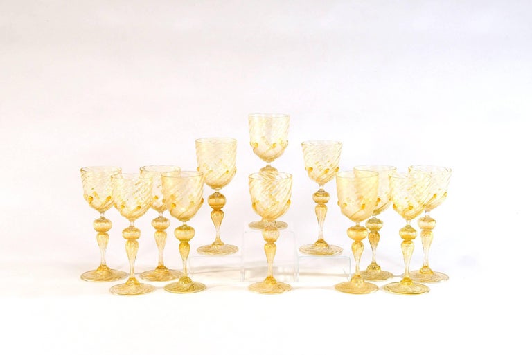 Offering an amazing set of 12 wine goblets that will be the talking point of your dinner conversation. These hand blown goblets scream gold! Clear glass filled with gold leaf and standing 9