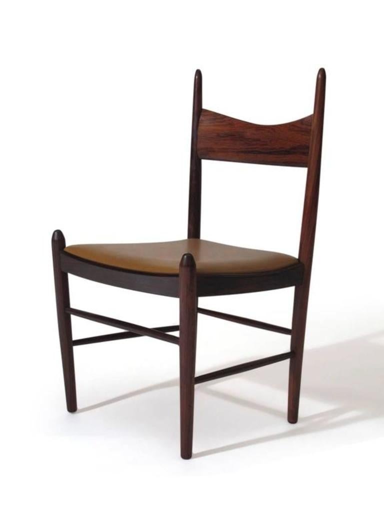 Set of twelve rare Rosewood dining chairs designed by Vestervig Eriksen for Brdr, Tromborg, Denmark. Handcrafted solid Brazilian rosewood with sculpted back and turned legs. Strong construction and sturdy. Price includes upholstery in choice of