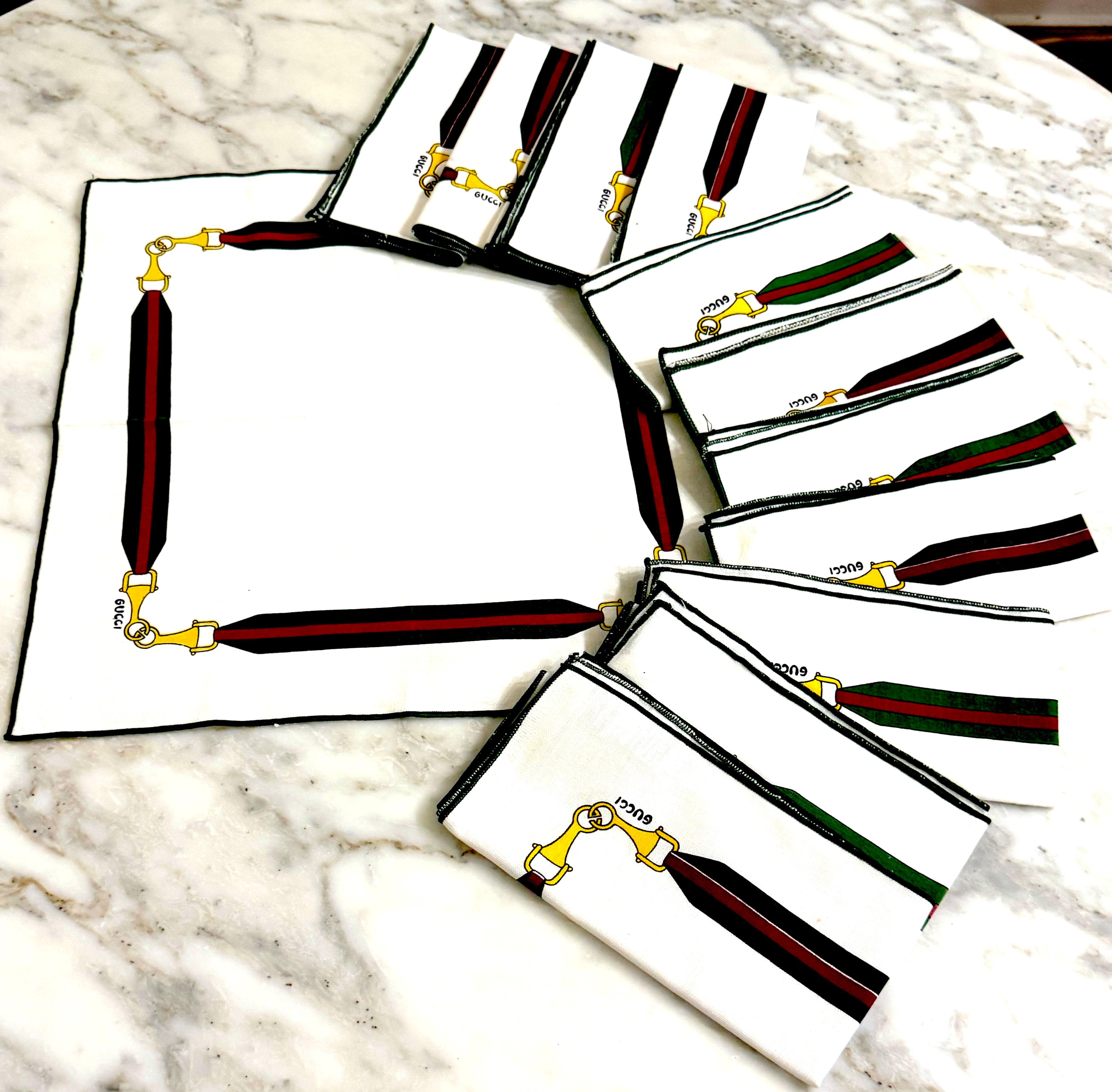 Set of Twelve Vintage Gucci Equestrian Napkins with Horsebit Motif, Signed, with Original Storage Bag and Authenticity Card

Italy, circa 1970s–1980s

Dimensions: Each napkin measures 16