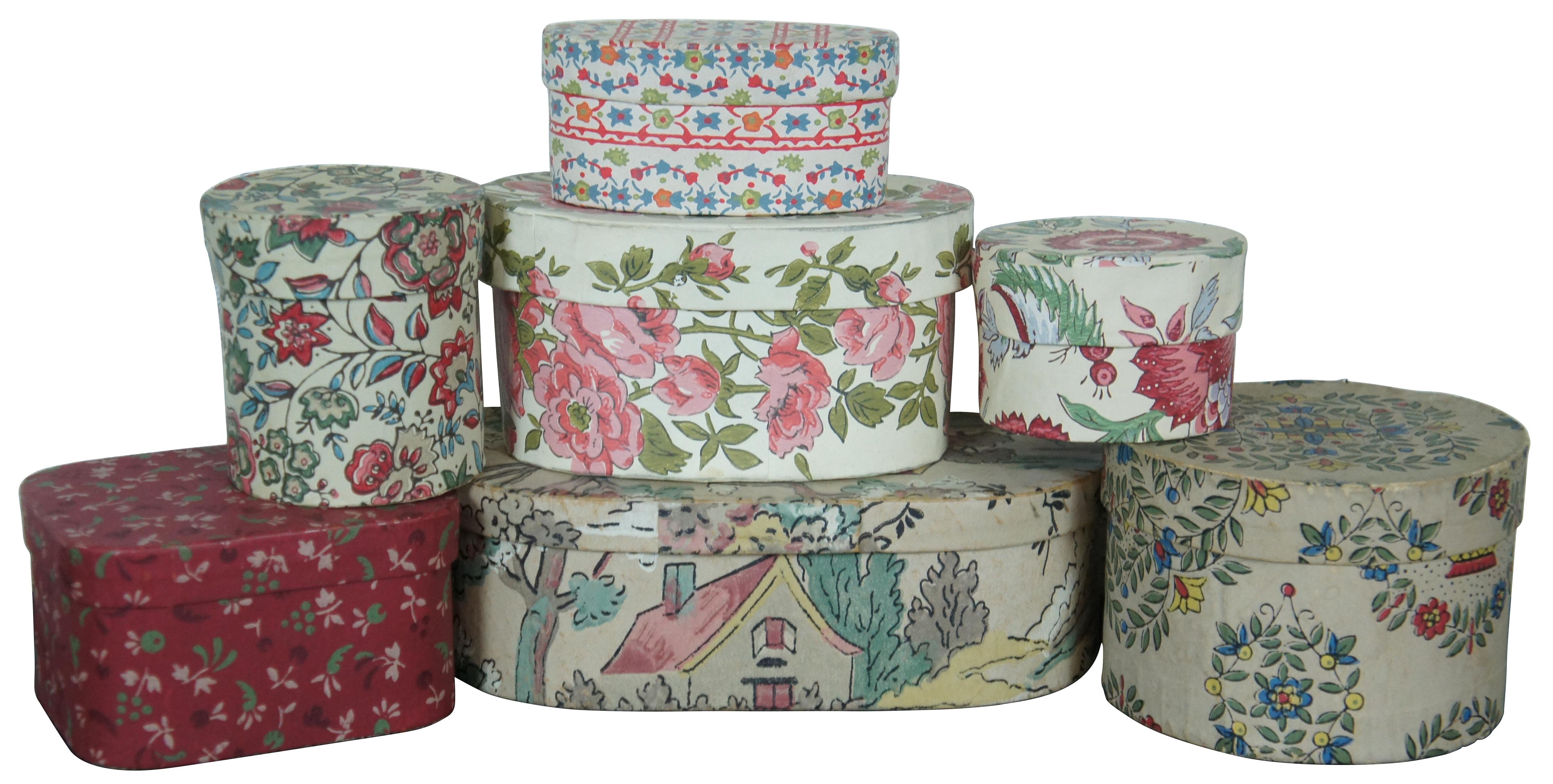 Twelve vintage and antique 20th century paper band boxes of various sizes, some nesting and finished in a variety of patterned papers and lined with book / magazine pages. 

Largest - 15” x 11.75” x 14.25” / smallest - 3” x 1.75” (width x depth x