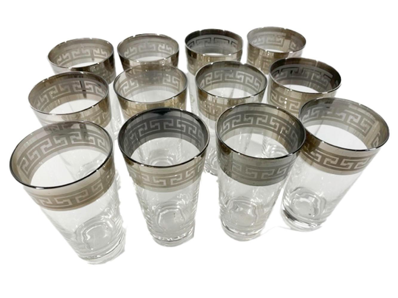 Twelve Mid-Century Modern highball or water glasses in the manner of Dorothy Thorpe, with a wide silver band at the top embossed with a Greek key motif.