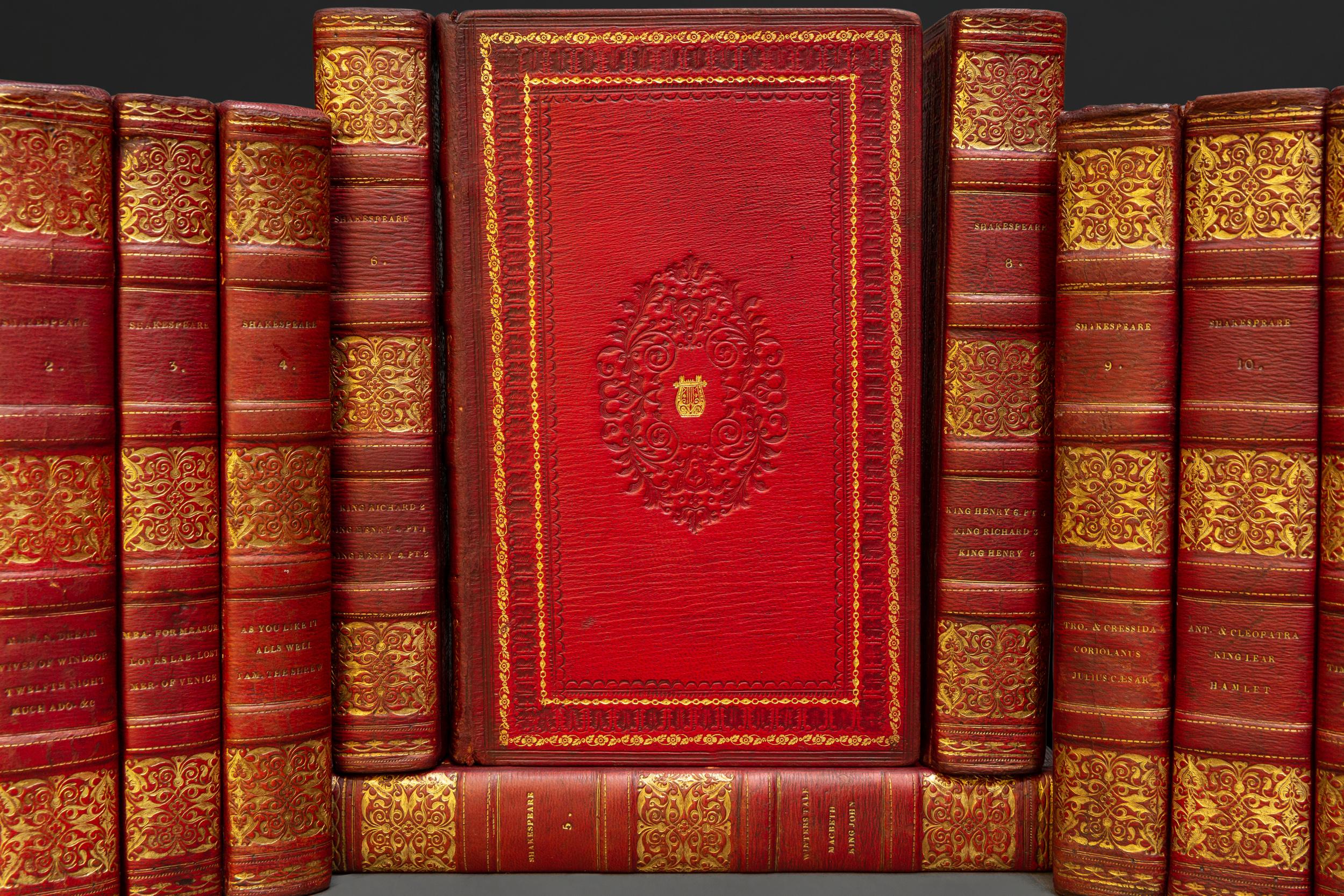 12 Volumes. Mr. Rowe. The Dramatic Works of William Shakespeare. Bound in red morocco. Blind tooling on covers. Marbled endpapers. All edges gilt. Raised bands. Gilt on spine. Published: London: Thomas Tegg 1812.