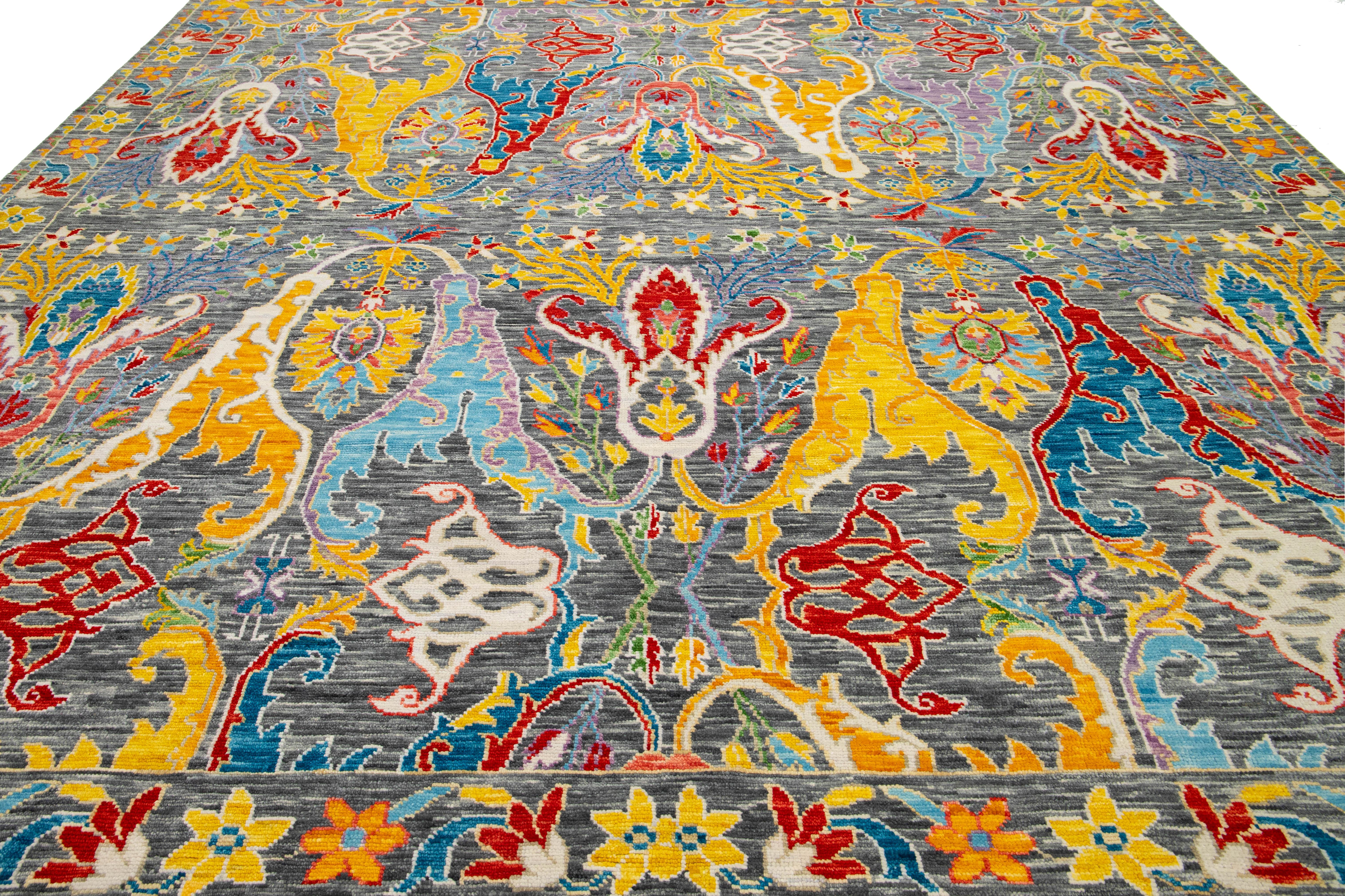 This contemporary Oushak-style wool rug beautifully combines modern design elements with the timeless charm of traditional Oushak aesthetics. Its unique gray background is accented by vibrant floral patterns that display a stunning array of colors,