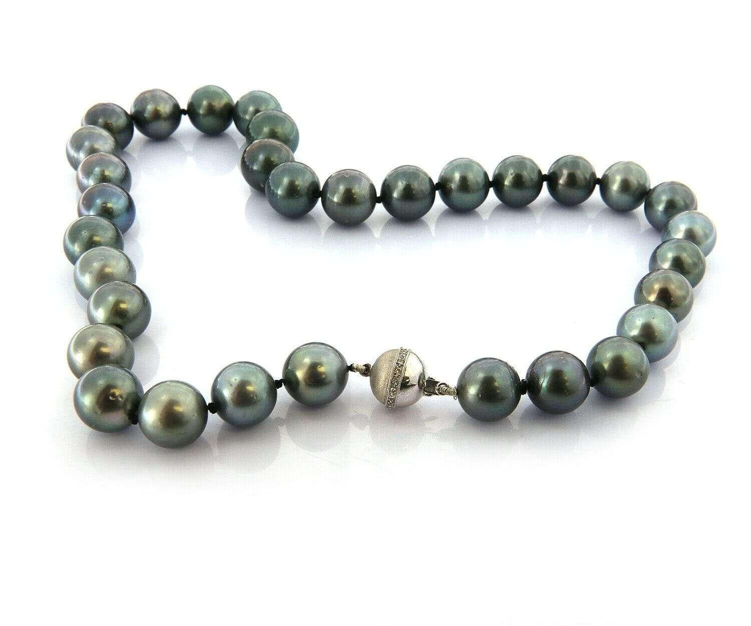 12.0 – 12.5 MM Black Cultured Tahitian Pearl Strand Necklace With 18K Clasp

Black Cultured Tahitian Pearl Strand Necklace
18K White Gold Clasp With Diamonds
Diamonds Carat Weight: Approx. 0.10 CTW
Necklace Length: Approx. 19.0 Inches
Weight: