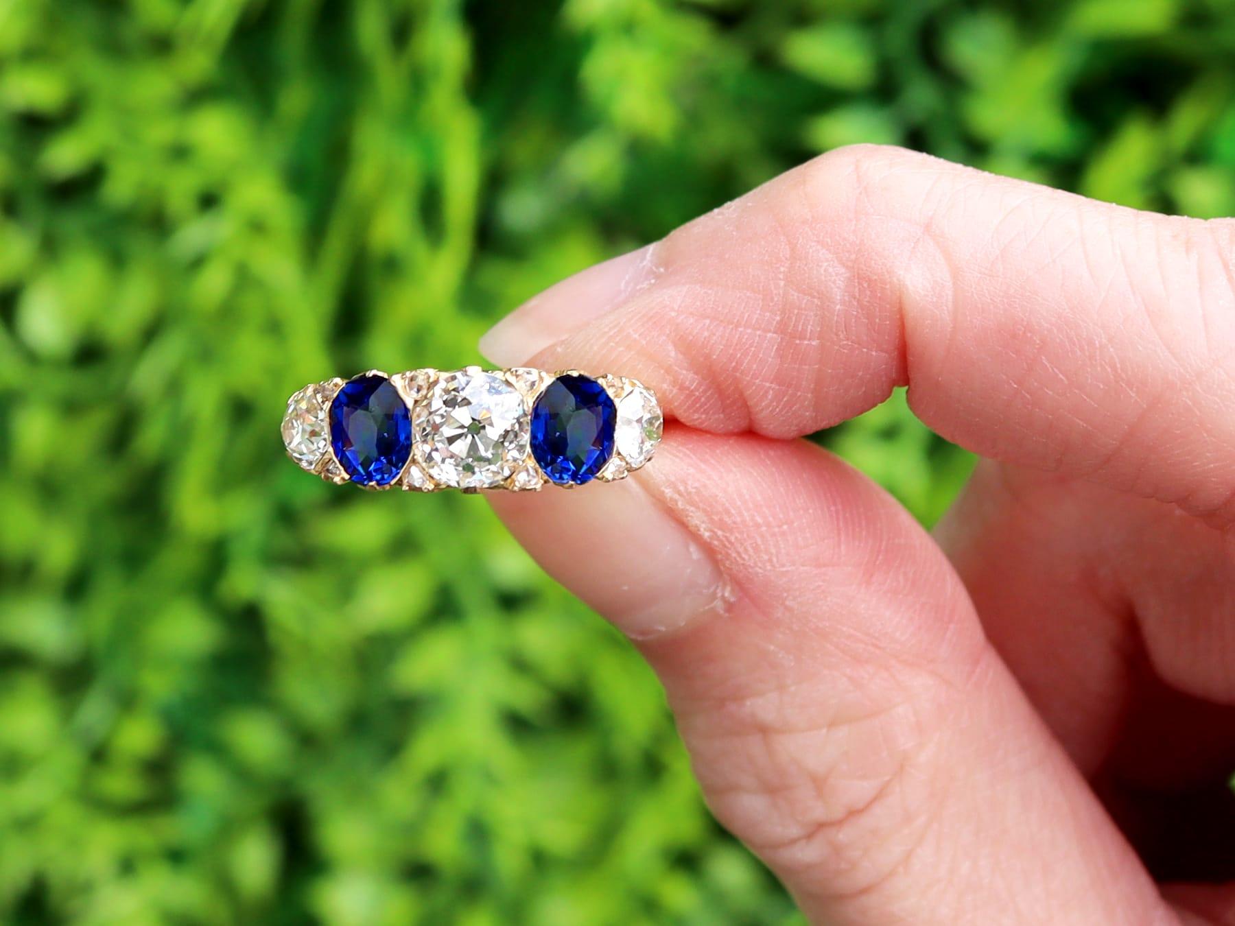 A stunning, fine and impressive antique 1.20 carat Basaltic sapphire and 1.59 carat diamond, 18 karat yellow gold five stone ring; part of our diverse diamond jewelry and estate jewelry collections.

This stunning, fine and impressive antique