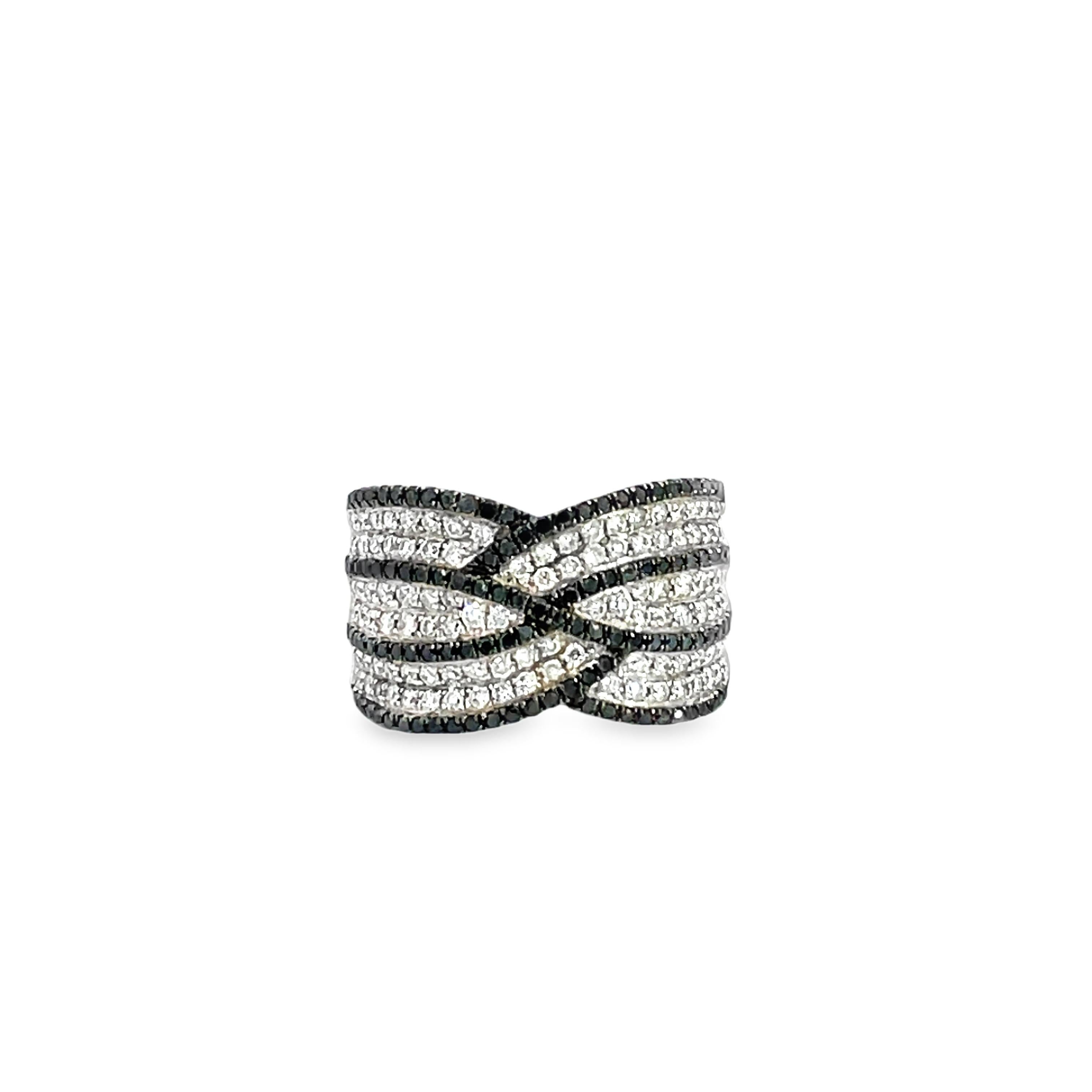 This Black and White Diamond Ring is a stunning and timeless accessory that can add a touch of glamour and sophistication to any outfit. 

This ring features 1.20 Carats of Round Black and White Diamonds.  This ring is set in 14K White Gold, and