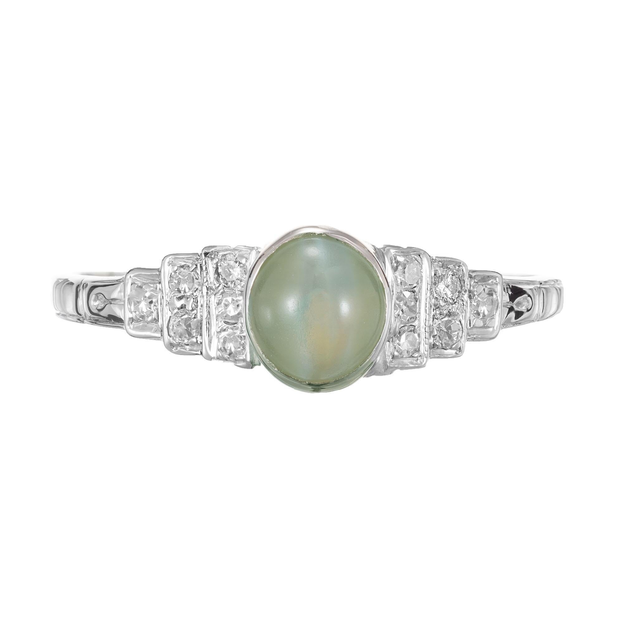 Chrysoberyl cat’s eye and diamond Art Deco engagement ring. Chrysoberyl cabochon oval center stone with 12 round accent diamonds in a Platinum setting. Circa 1929.

12 round diamonds approx. total weight .12cts
1 oval cabochon cut Chrysoberyl cat’s