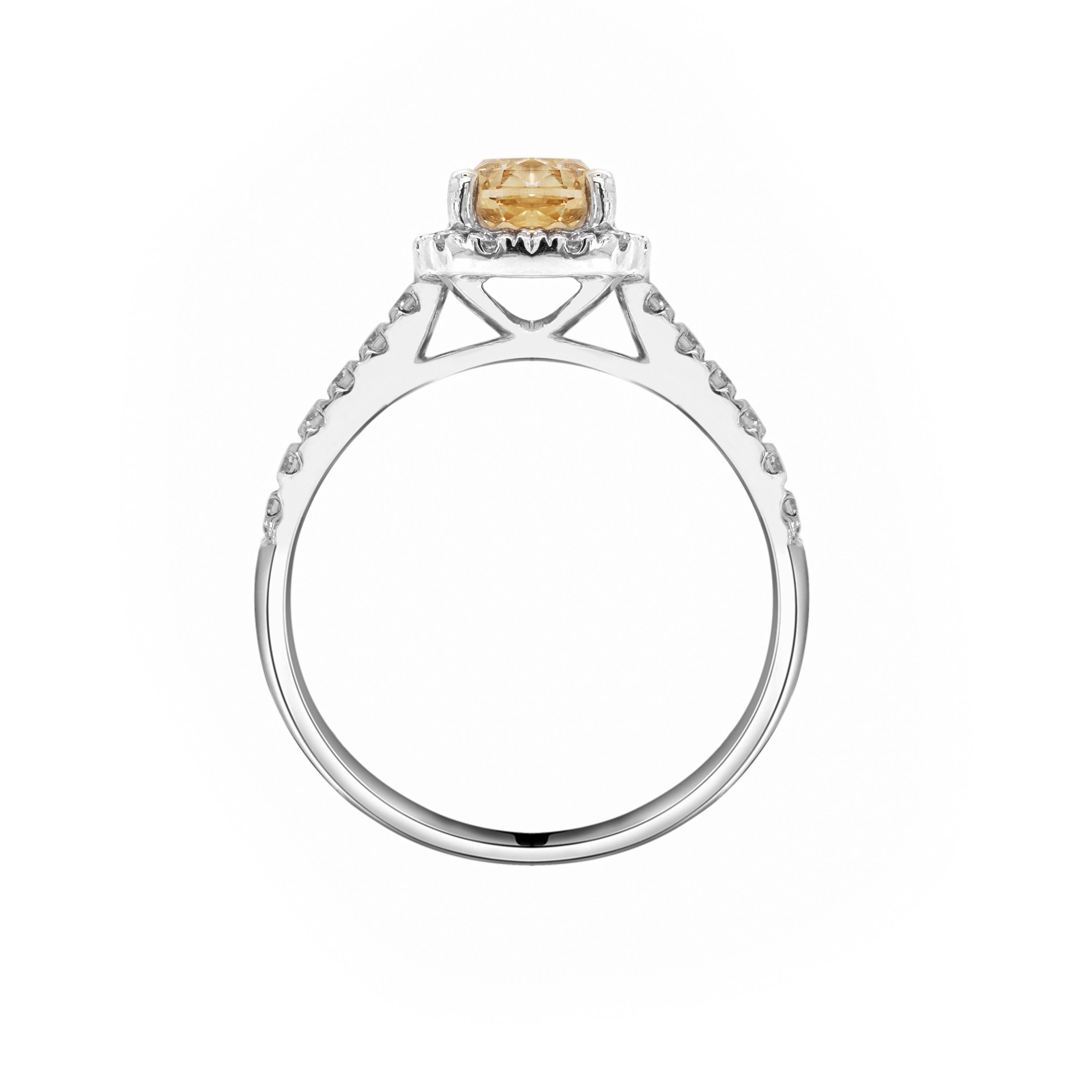 This stunning engagement ring features a champagne coloured cushion cut diamond weighing 1.20ct mounted in a four claw, open back setting. The gorgeous stone is surrounded by a halo of white round brilliant cut diamonds to give a wonderful contrast